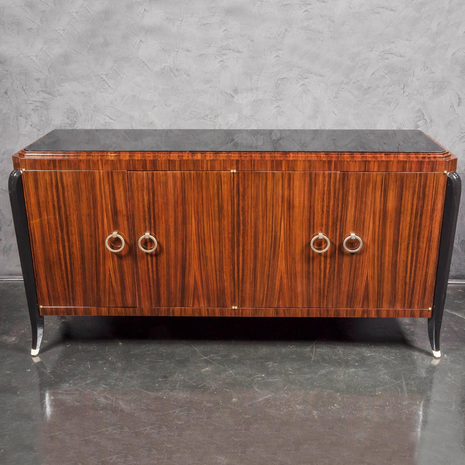 Beautiful sideboard in Indian rosewood with black lacquer legs and octagonal black glass top. Brass hardware pulls. Four drawers in interior with two shelves. Art Deco modernistic design. Also available as dresser with six drawers. Available in