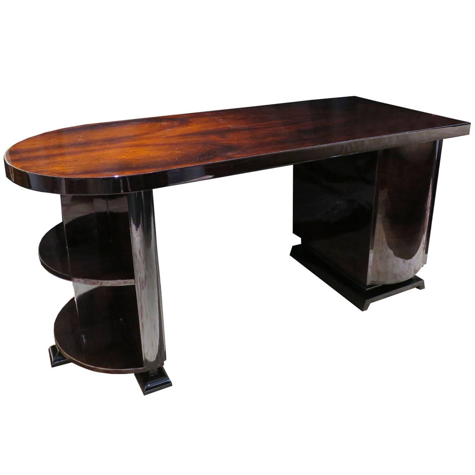 Handsome curved half-round desk with rosewood veneer and high gloss lacquer finish. The desk features a modernistic design with three curved drawers and two stacked open curved shelves.