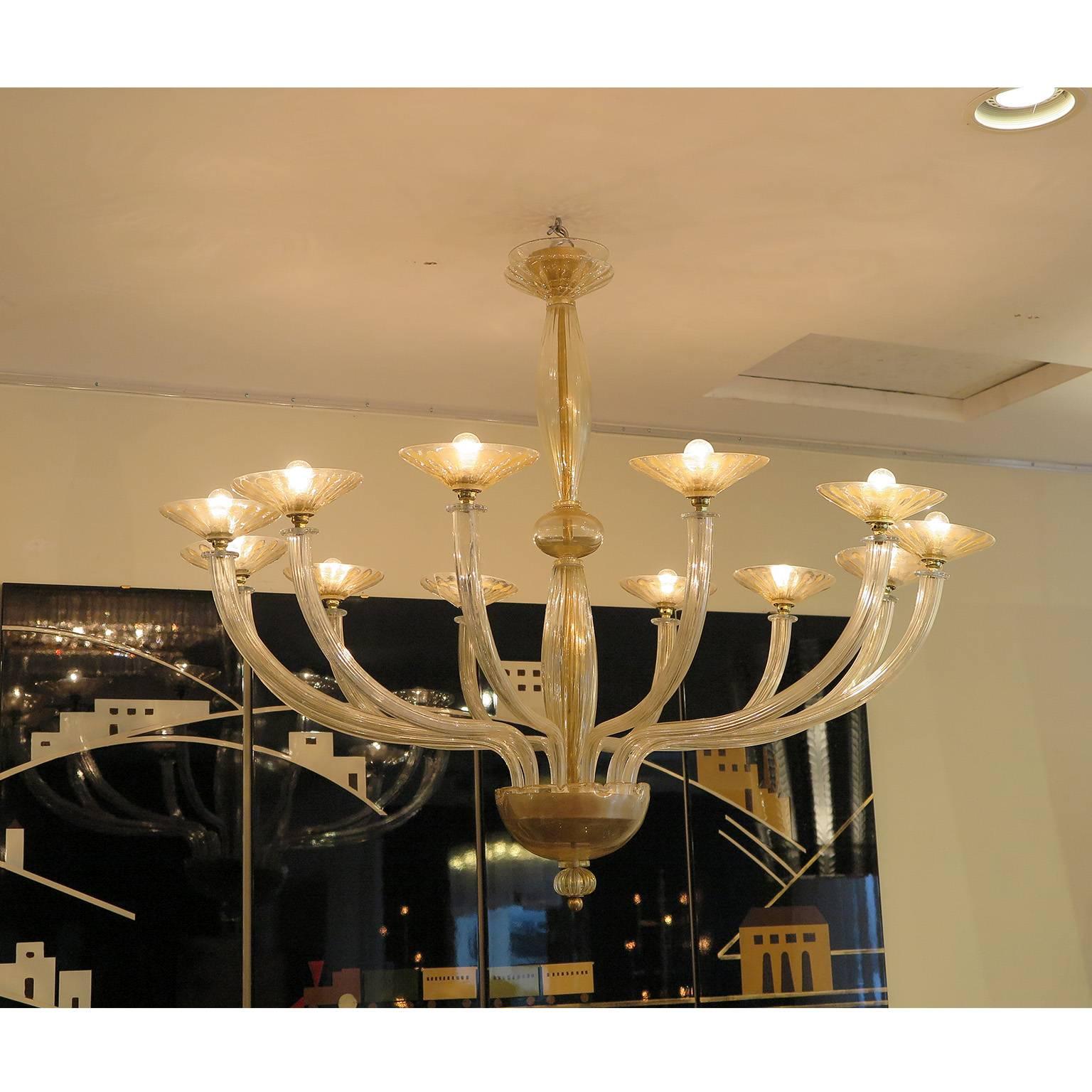 Stunning Murano glass chandelier from Italy, circa 1960s-1970s. Features 12 curved arms with handblown opaque glass with gold leaf details.