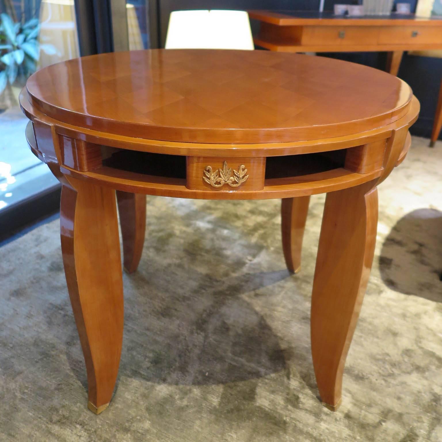 Large round side table in fruitwood with sycamore parquetry on top. Four gold leaf floral details on apron with eight inches. Four gold leafed sabots. By Jules Leleu.