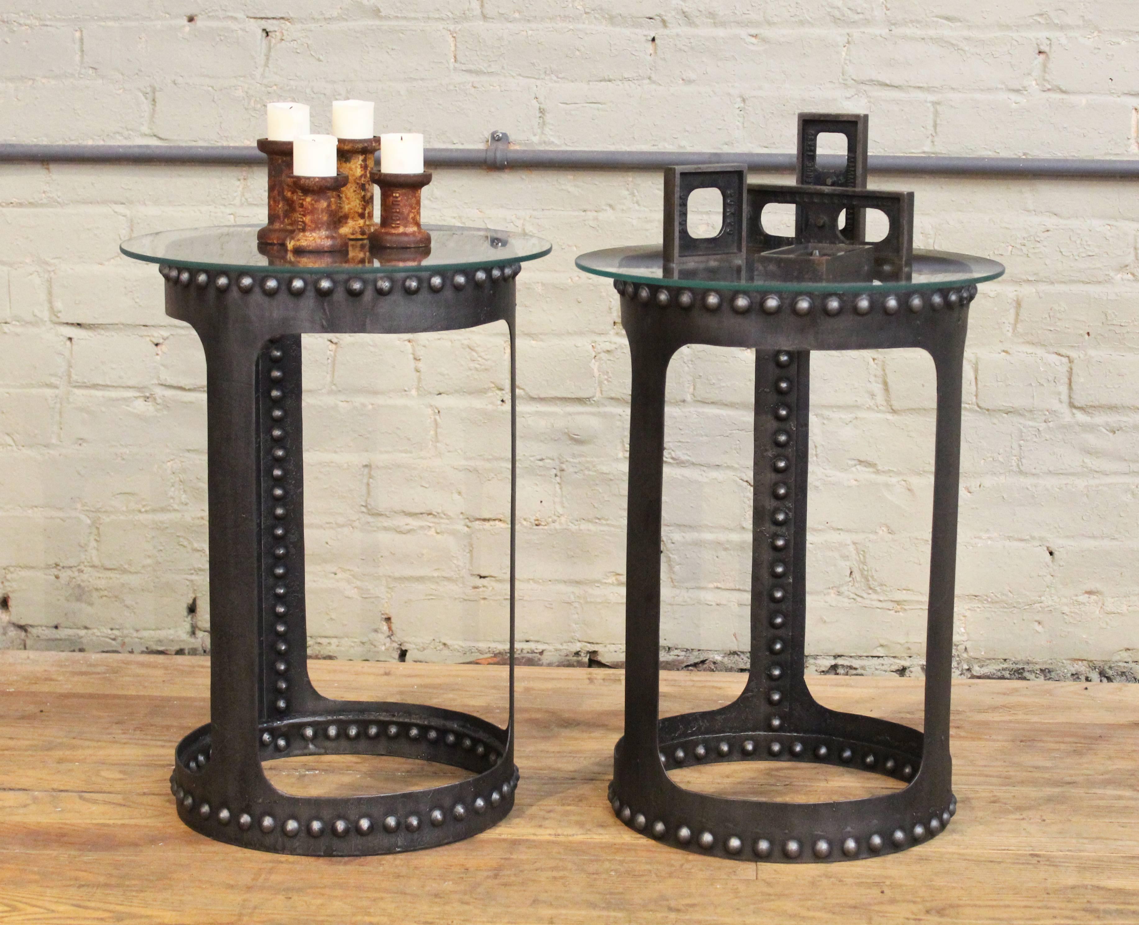 Riveted steel, metal and glass end or side tables. Brutalist, Industrial Style. Pair one (two and three) in a set of five. 13" in diameter, (15" diameter glass) 19 7/8" in height with glass. Vintage Industrial by Get Back, Inc.