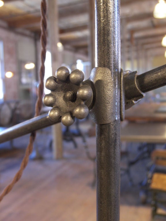 Bespoke vintage industrial adjustable cast iron floor lamp, task or reading light. Top arm is adjustable in height via a cast iron knuckle fitting. Angle is adjusted via a thumbscrew. Base measures 9 1/2