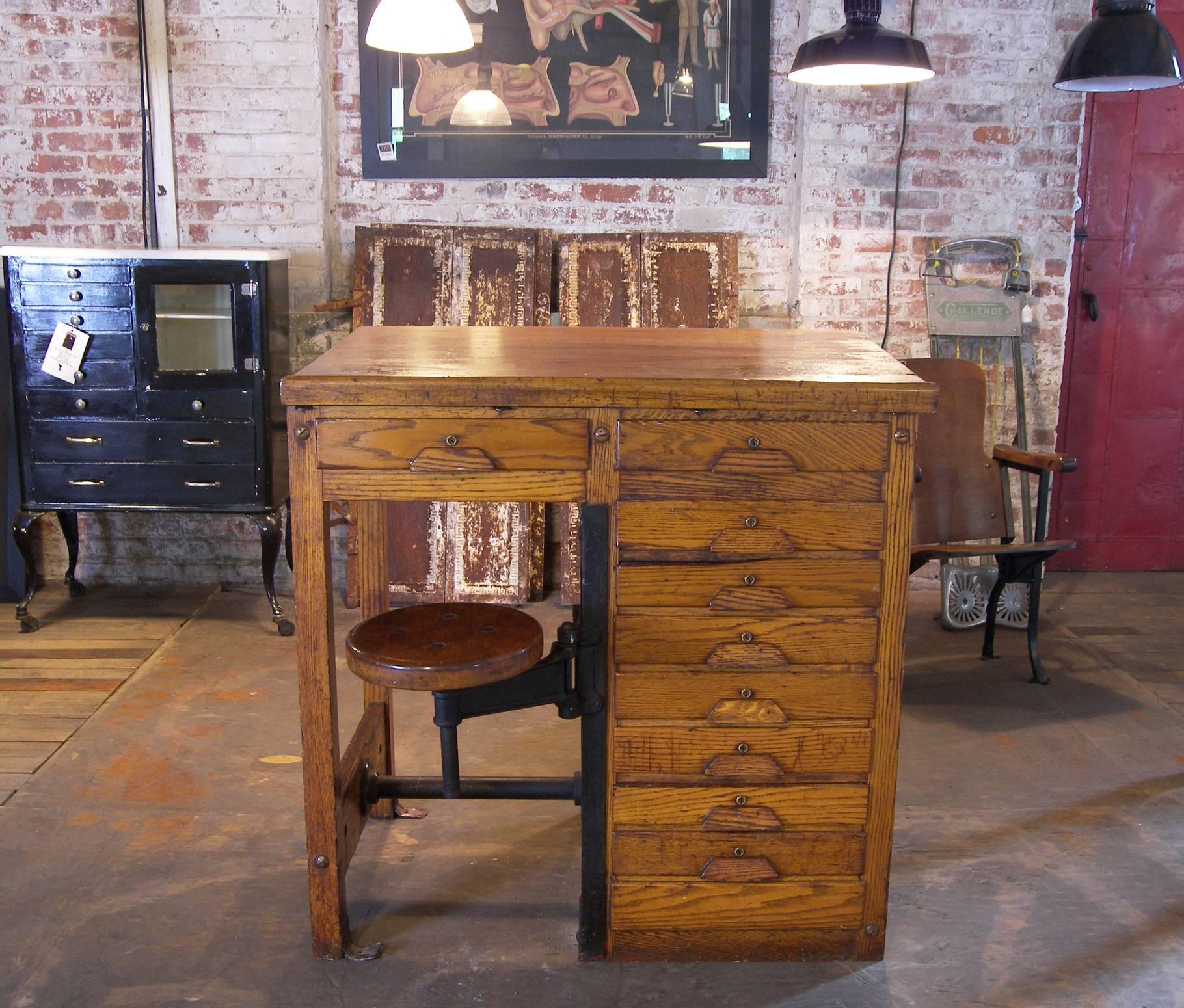 Vintage drafting / laboratory table or desk with swing out seat and ast iron fitting. The top slopes from 38 1/2 to 37 1/2