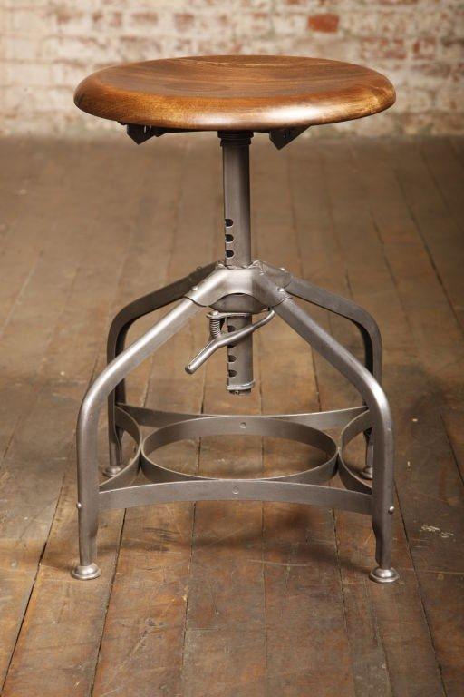 Vintage industrial backless adjustable authentic Toledo stool. Scooped solid wooden maple seat adjusts from 16 1/2 - 24
