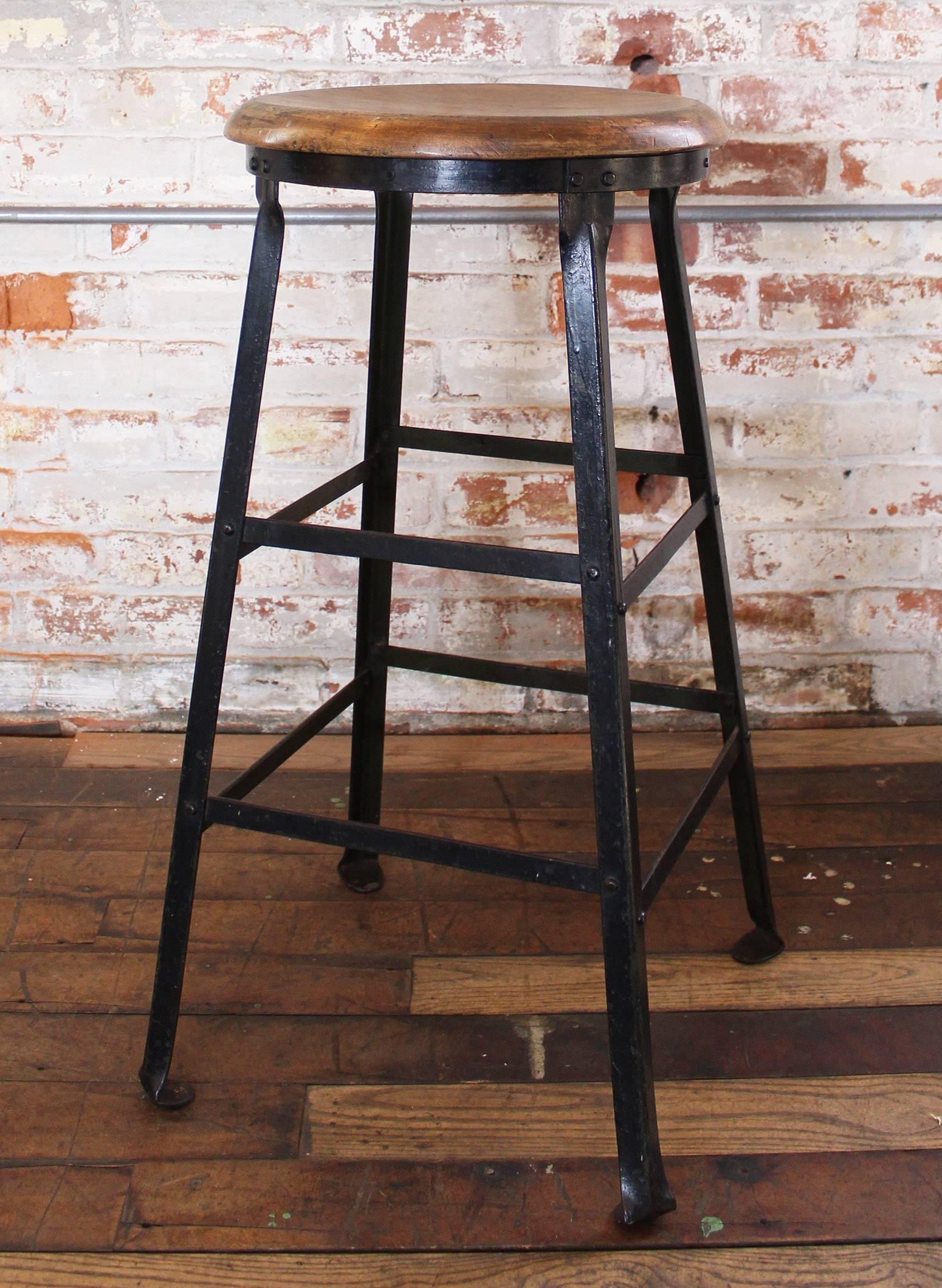 Vintage Industrial rustic wood and metal bar stool. Seat diameter measures 14". Seat thickness measures 1". 28 1/2" in height, 15 3/4" in width and 15 3/4" in depth.