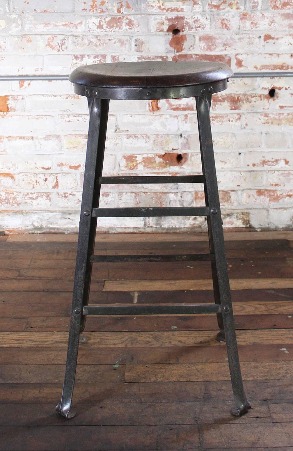Rustic bar stool backless kitchen wood and metal bar stool. Great vintage patina. Solid wood seat measures 14" in diameter and is 7/8" thick. Seat height measures 27 3/4" and base measures 16" x 16". We have more available