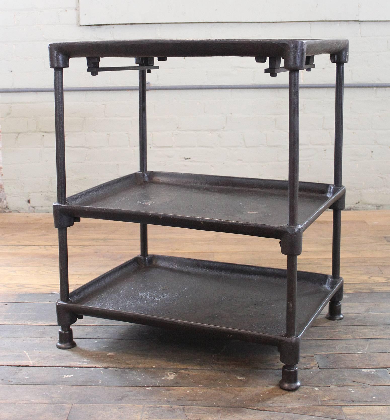 Three-tier cast iron vintage Industrial side table, bar cart with adjustable shelves and cast iron feet. Bottom two shelves adjust via a square set screw. Dimensions are 25 1/2