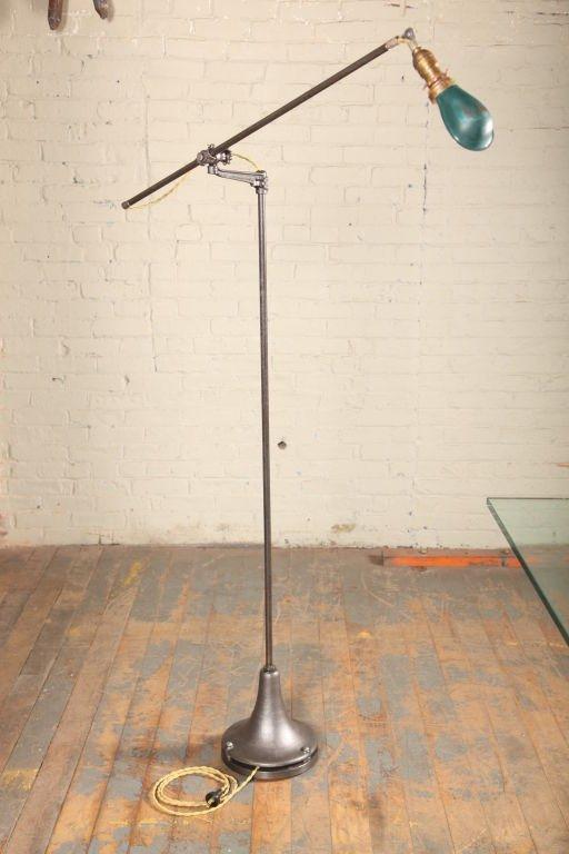 Original, adjustable floor lamp with enamel shade, cast iron knuckle joint, bracket & base. Lower arm measures 38