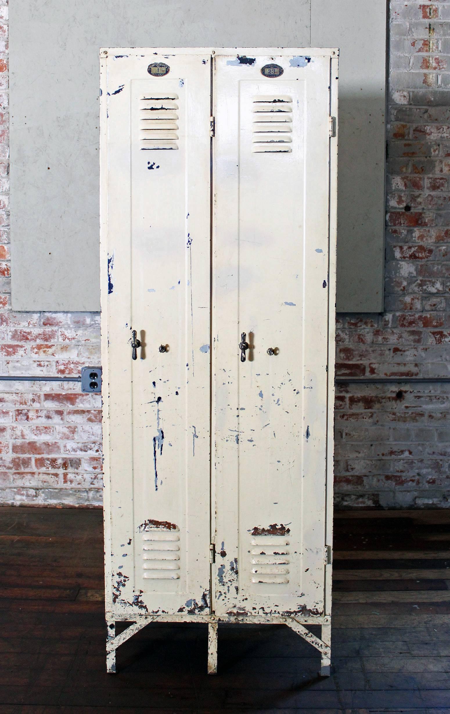 Set of vintage Industrial steel or metal lockers with brass knobs and number plates. Measures: 24 1/4" in width, 66 1/4" in height, 15 3/4" in depth, 17" in depth overall including knobs. Usable space inside locker is approx