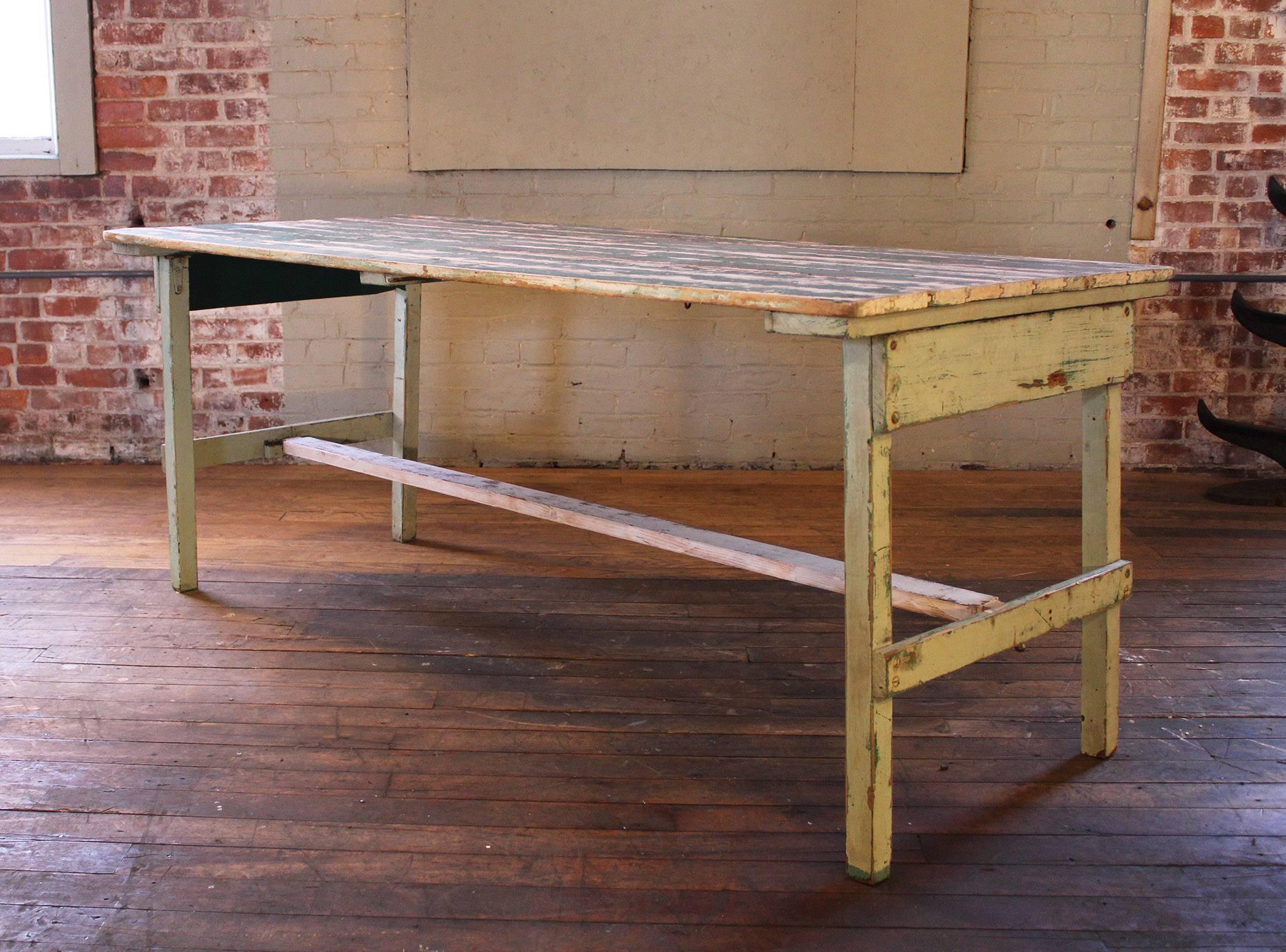 Vintage Industrial rustic farm folding painted wood dining work table. Beautiful patina on the old painted wood. Great space saving table. Table has movement to it due to the ability to fold up. More suitable as a display table for lighter objects.