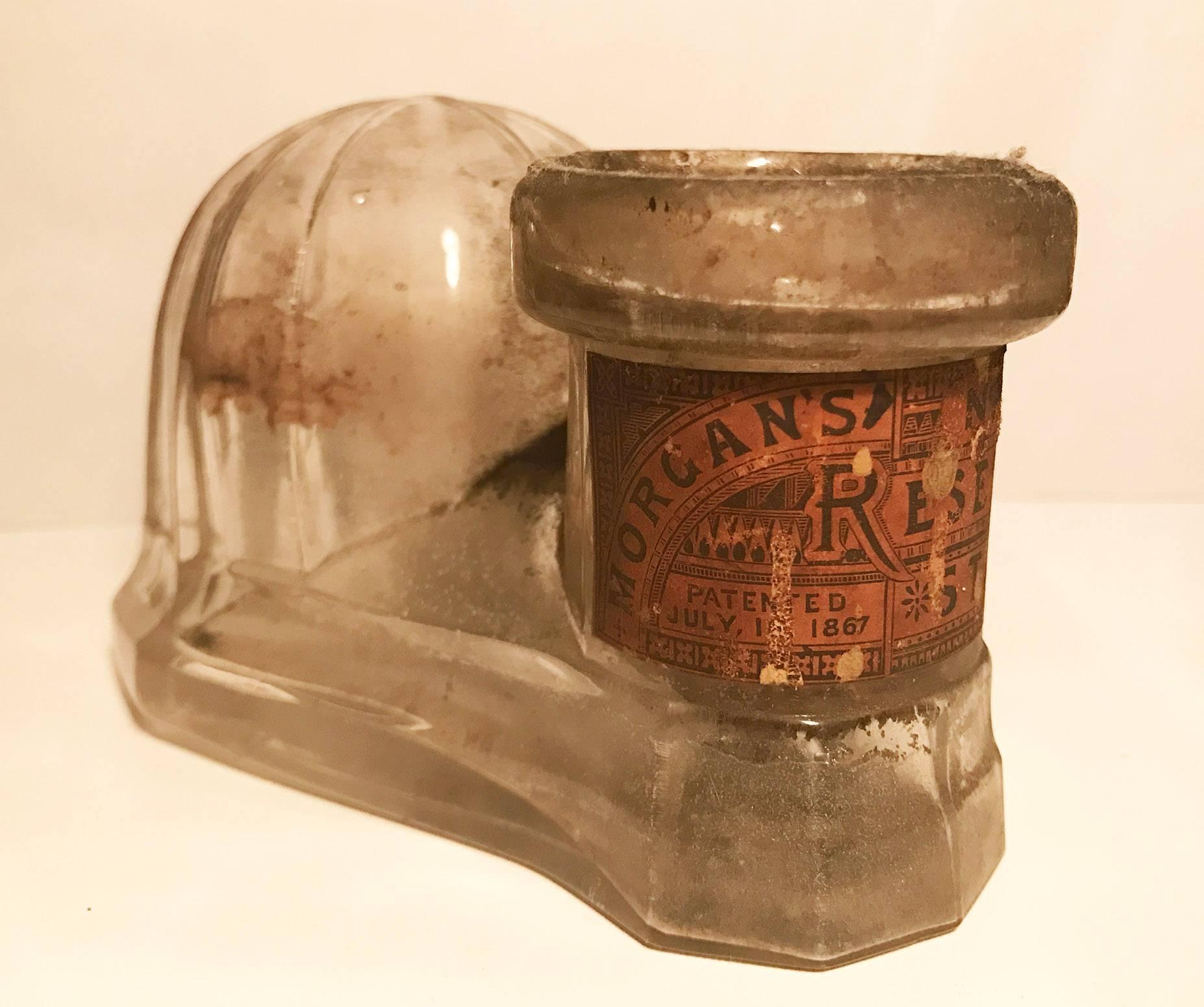 Antique clear dome top glass inkwell bottle reservoir stand Morgan's patent 1867 with paper label.