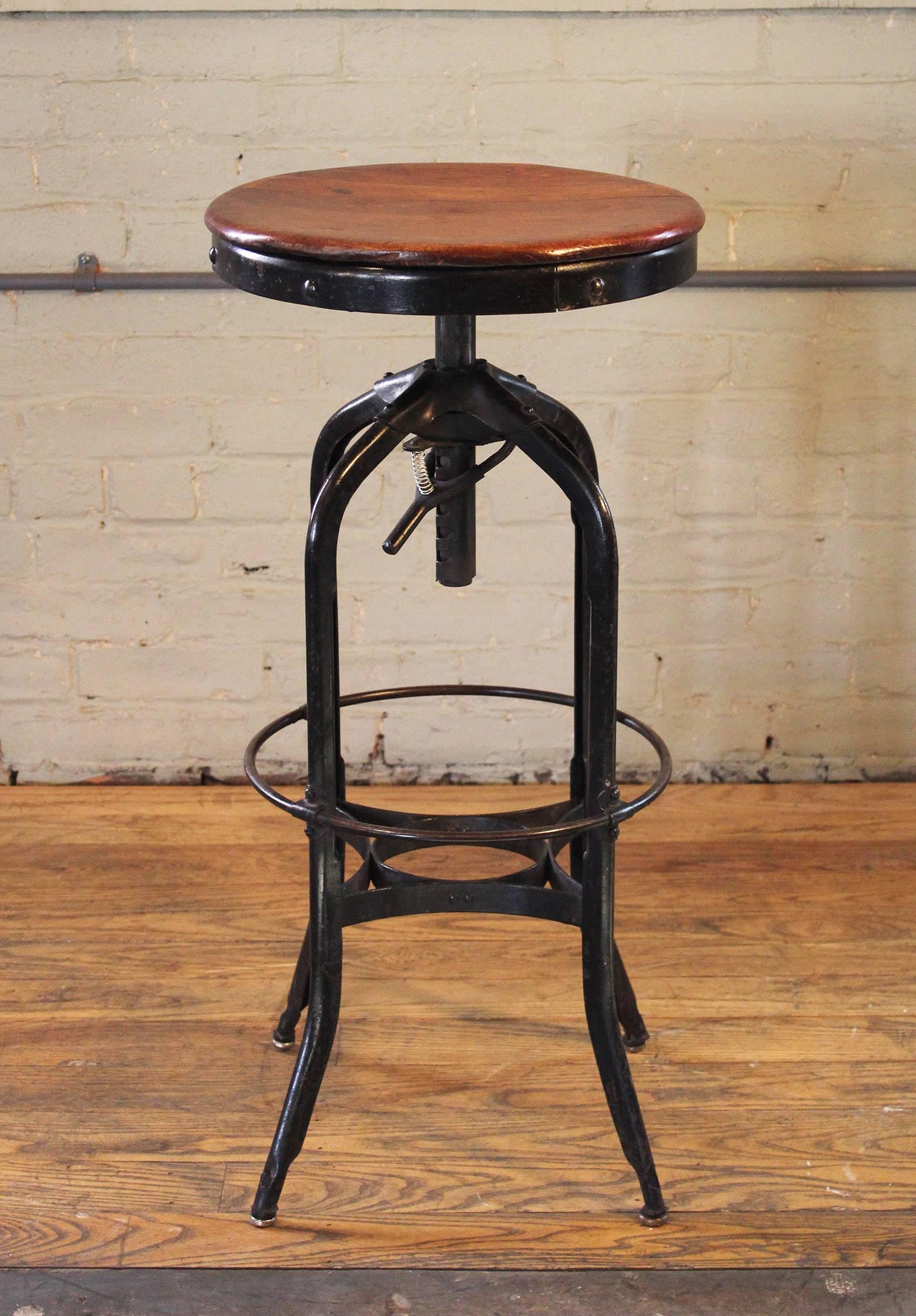 Original vintage Industrial Toledo backless wood and metal adjustable bar stool. Black base. Seat height is adjustable from 28 1/2