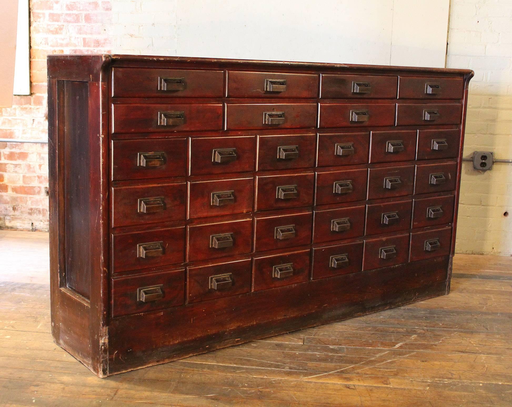 Vintage Industrial wood hardware multi thirty two-drawer storage apothecary cabinet counter. Overall dimensions 72" x 18" x 42" in height.