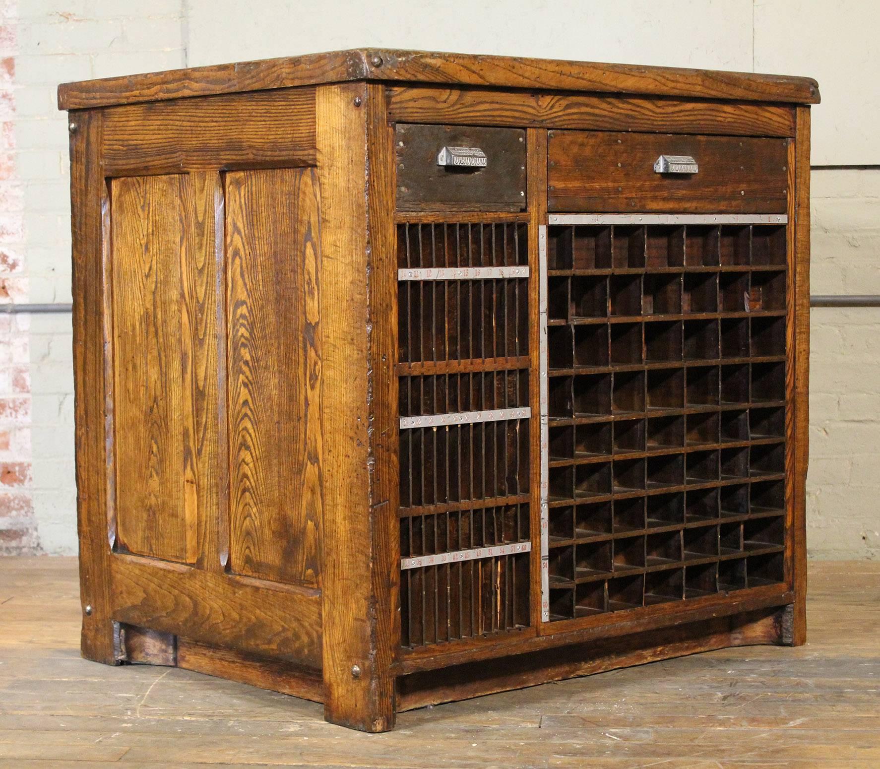 Vintage Industrial marble-top wooden counter storage parts cabinet made by the Tubbs Manufacturing Company, Ludington, MICH. Overall dimensions are 39 1/2" x 31 1/2" x 38 1/4" in height. Marble-top measures: 36" x 28". Steel