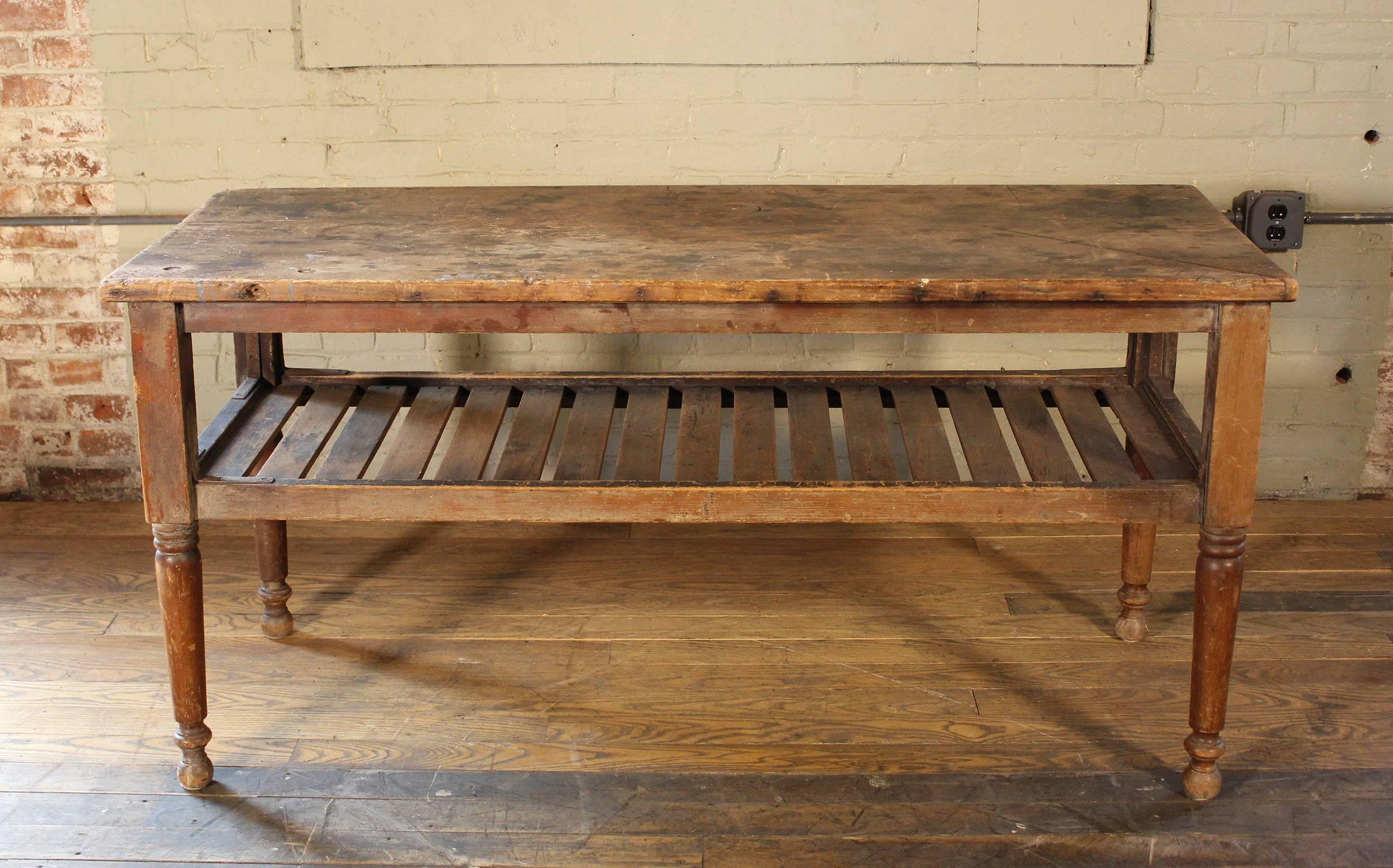 Beautiful antique vintage Country Farm console rustic wooden table, perfect for retail display. Wood is pine. Top is a single board. Features forged iron brackets and turned legs. Overall dimensions are 59 1/2" x 24" x 29 1/4" in