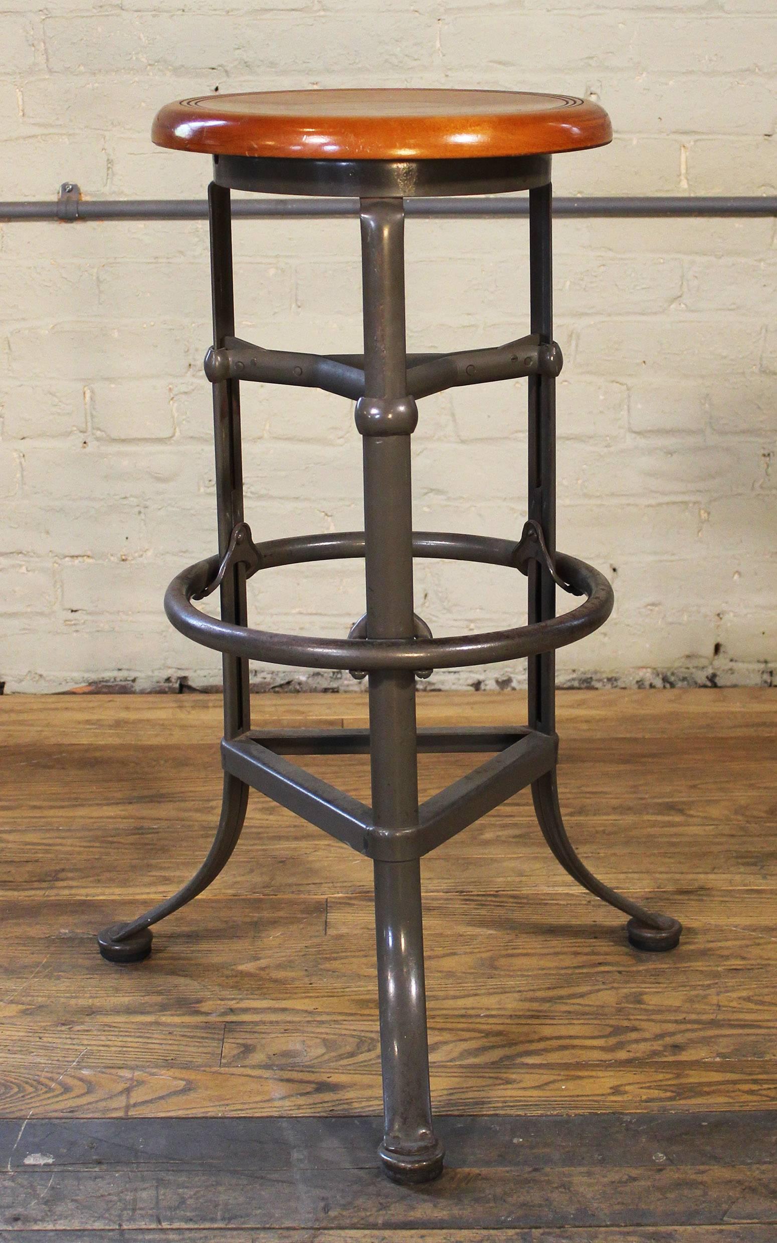 "Rite Hite" automatic adjustable vintage Industrial wood and metal bar stool made by the "Dependable Manufacturing Company," Omaha, Nebraska. Tag Reads, to adjust, no tools are required, simply hold stool to floor by stepping on