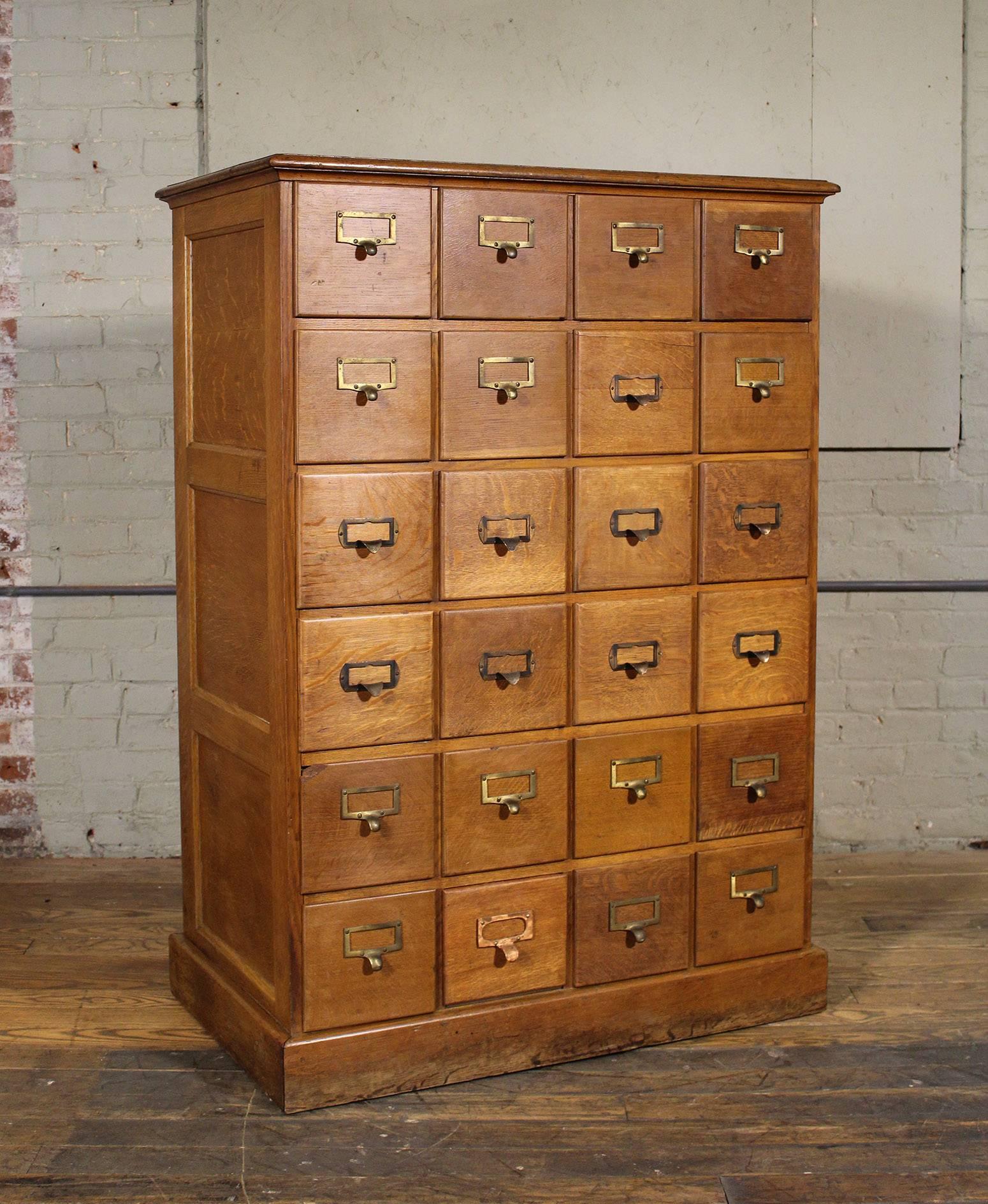Vintage Industrial multi-drawer oakwood storage cabinet. Overall dimensions are 36 1/4" in width, 21 5/8" in depth and 51 3/4" in height. Inside drawer dimensions are 6 7/8" in width, 6 1/2" in height and 18" in depth.