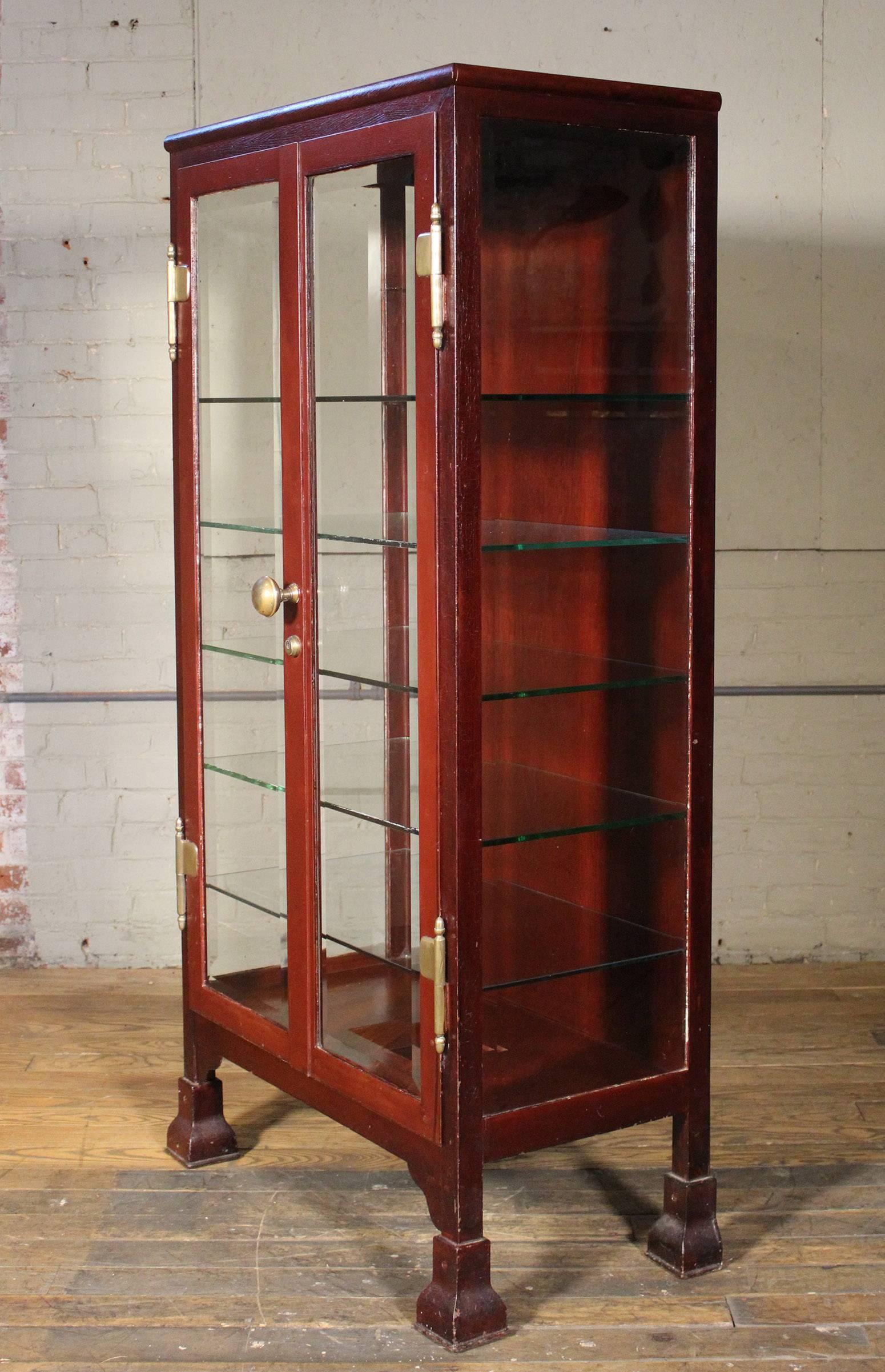Vintage Industrial glass and metal curio/medical storage cabinet/cupboard with five glass shelves. Distressed crackled paint over metal.
