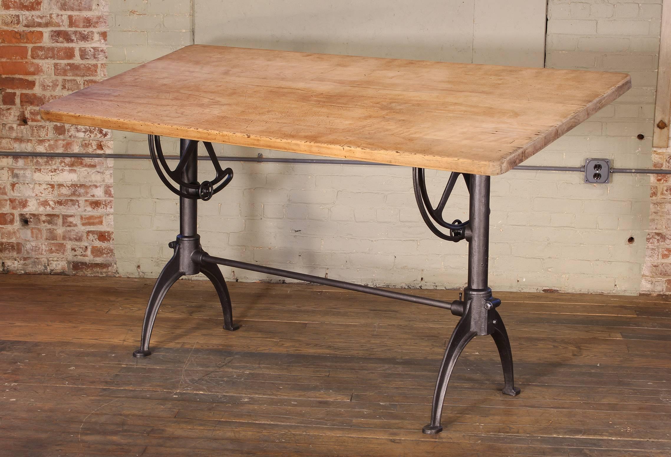 Vintage tall adjustable drafting table, cast iron and maple. Top can be tilted to lay flat to fully vertical.