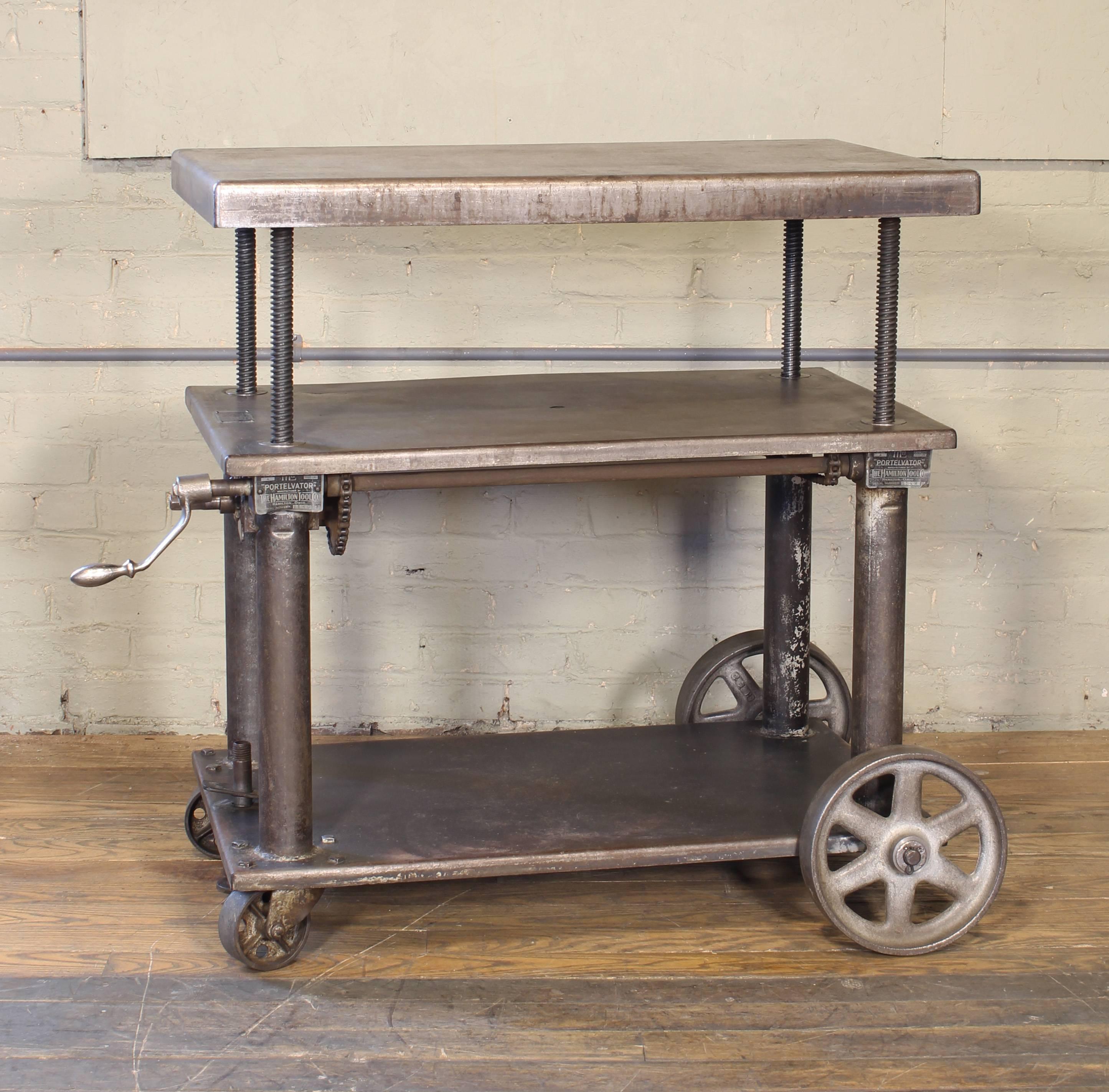 Original vintage Industrial adjustable metal, steel rolling three tier lift bar cart / table with cast iron casters / wheels. Measure: Top is adjustable in height from 25 1/4