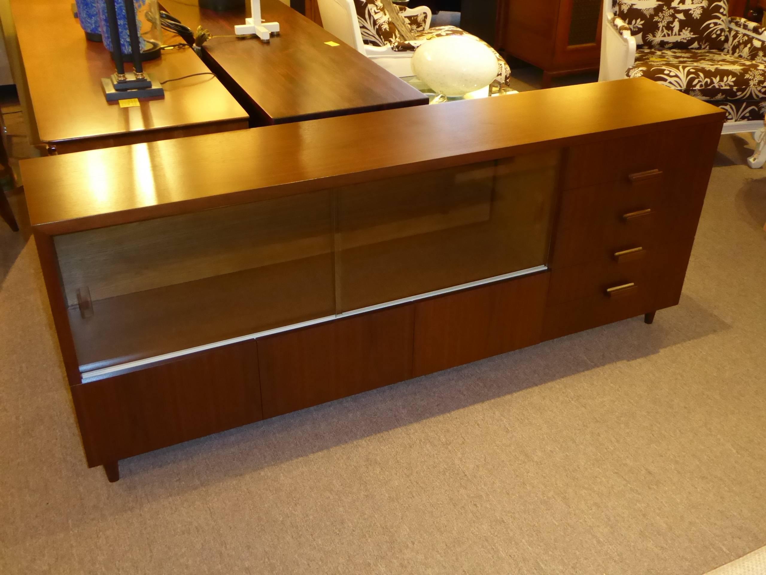1950s walnut credenza with drawers, glass doors and bottom cabinet. Exhibiting a wonderful scale of long and narrow, not too deep, this credenza was a custom bespoke design by Robert Law Reed, noted Miami architect of the early to Mid-Century.