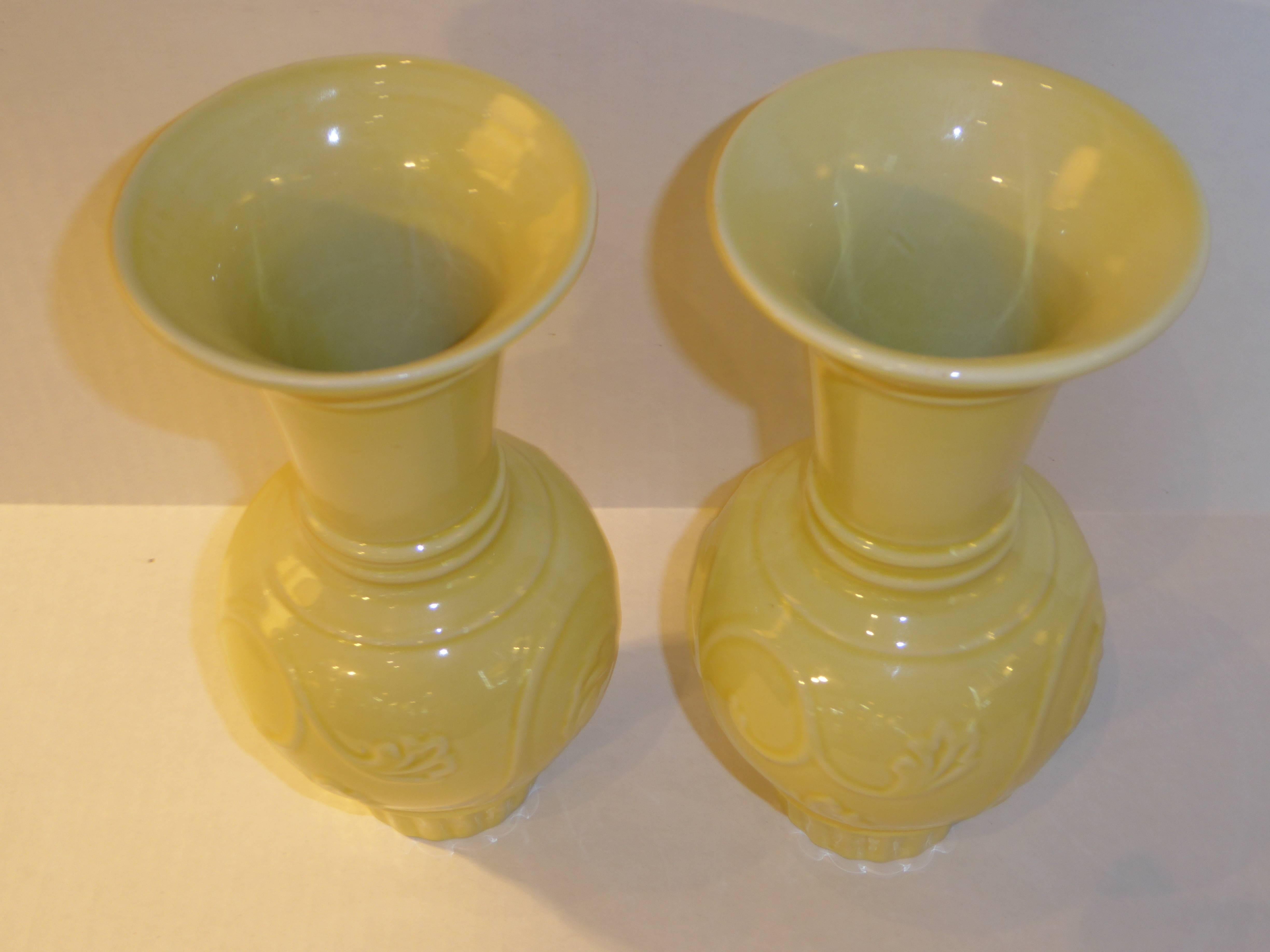 Rarely seen pair of Trenton Art China (TAC) Art Deco vases by Trenton Potteries in a very pale Citrus Yellow or Indian ivory glaze. Urn shaped with concentric rings at the flared rim tapering to a waist, with a stylized floral bulbous middle,