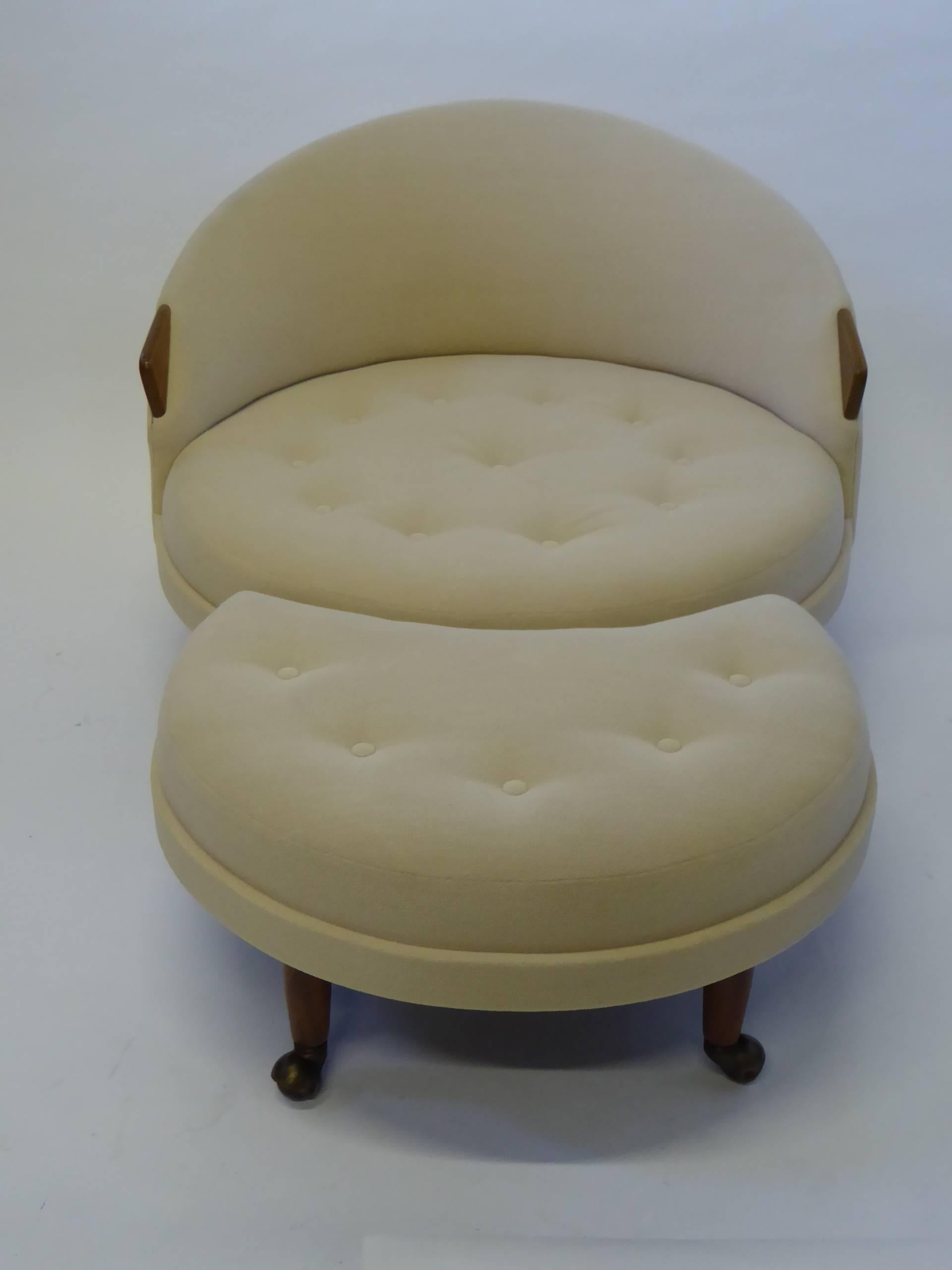 Wonderful tony design by Adrian Pearsall for his firm Craft Associates, this button tufted lounge chair with fitted ottoman has a comfortable low scale, sporting fat tapered walnut legs on casters and arms ending in walnut fins, echoing car tail