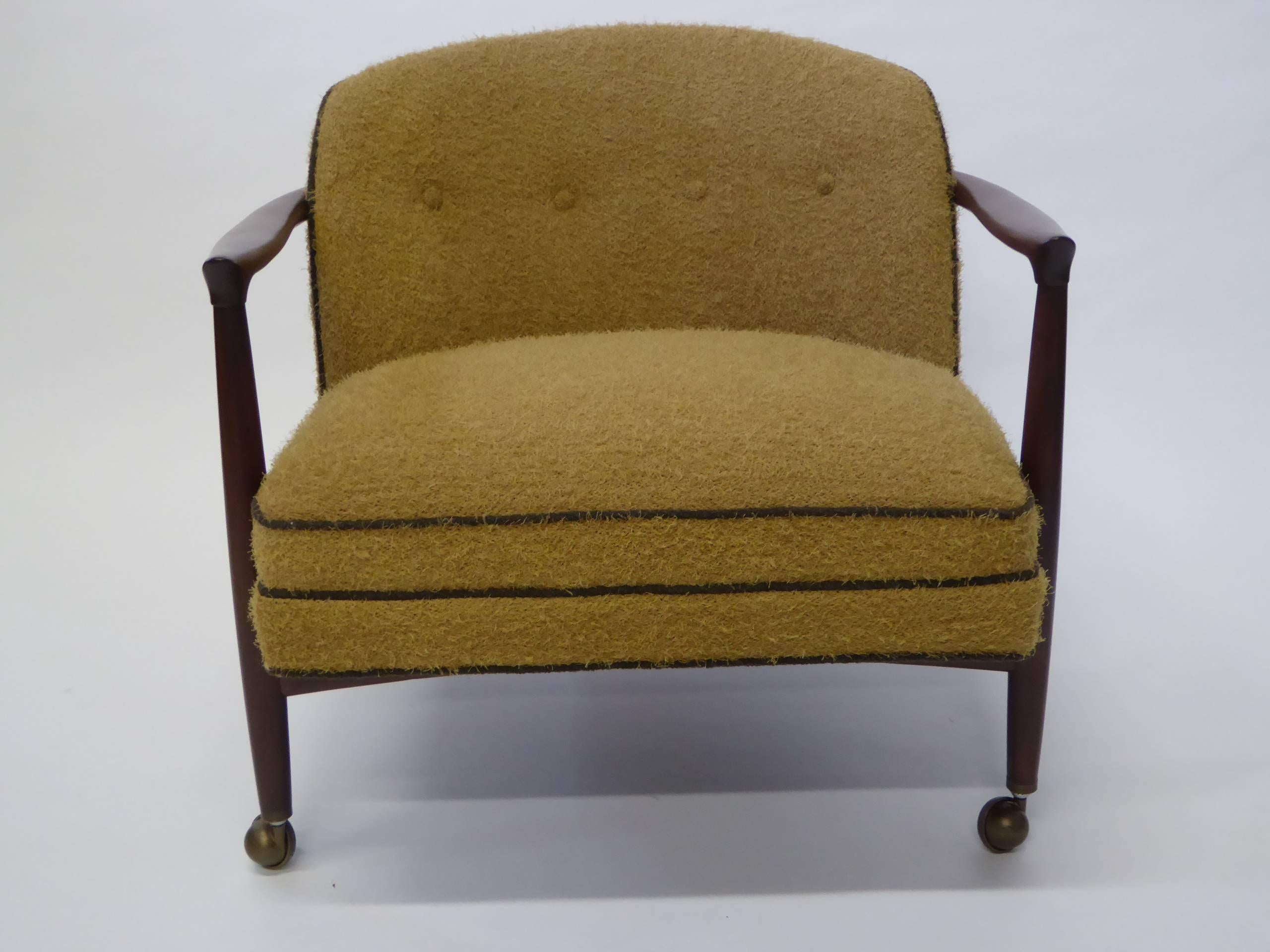 SOLD  With its beautifully sculpted and joined walnut frame this armchair by Ib Kofod-Larsen and produced in Denmark by France & Son is quite elegant and stately. Pure Danish modern, its floating rounded tufted back upholstered seat sports a nappy