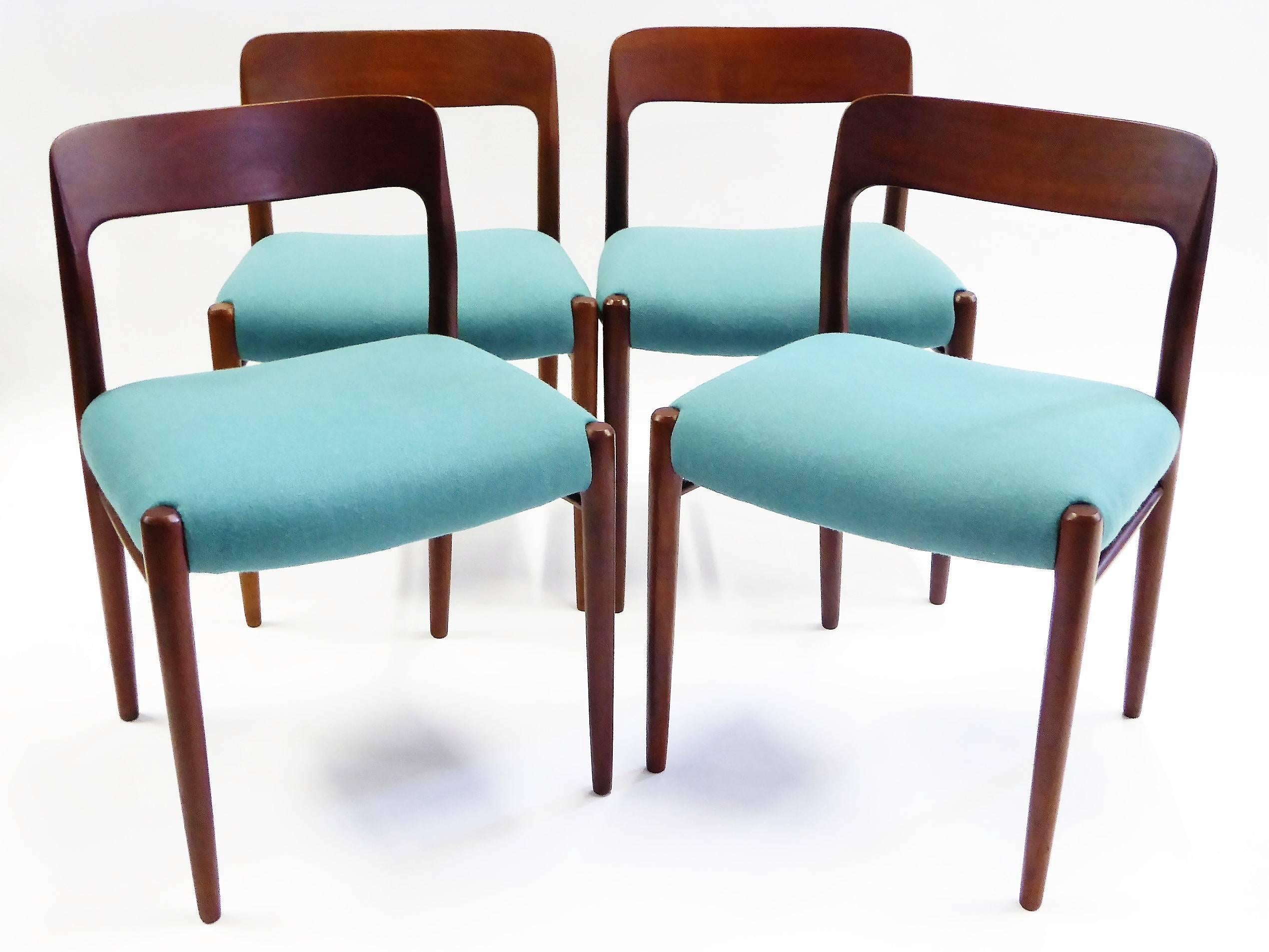 REDUCED FROM $2,650.
Warm dark figured teak highlights these four dining chairs designed by Niels Otto Møller in 1954 for his company JL Møller Møbelfabrik. Newly pushy upholstered seats in a seafoam wool weave. The artistry, quality and