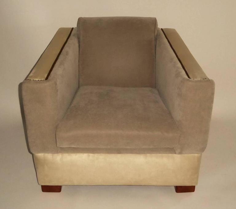 Inspired by Paul Frankl's 1939 speed chair, this early 1940s lounge chair has a great footprint and presence. Upholstered in cream and gray pale ultrasuedes, the gray with ostrich skin impression with dark brass nailhead trim. Masculine, comfortable