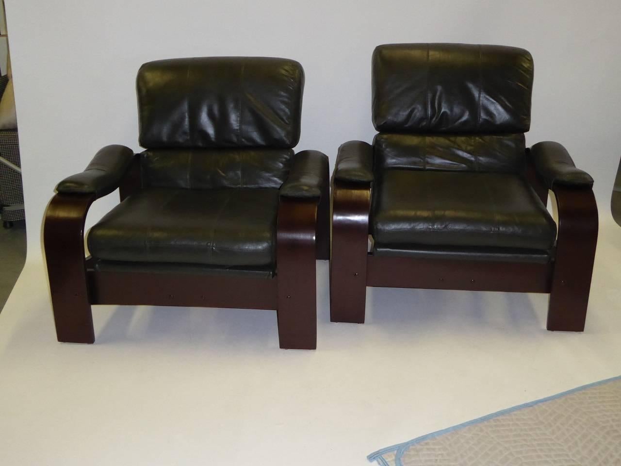 REDUCED FROM $3,450.
Pair of green leather and bentwood lounge chairs in the style of Alvar Aalto, the iconic Finnish designer. Supple and soft dark green leather cushions and arm pads highlight this pair with dark brown painted wood forms with the