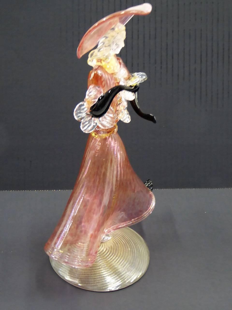 REDUCED FROM $450....Lovely Vintage 1950s Venetian blown glass figurine of a dancing courtesan with a large hat and flowing dress. Murano techniques of glass with gold inclusions throughout and a dress and hat of pale plum murine on a base of gold
