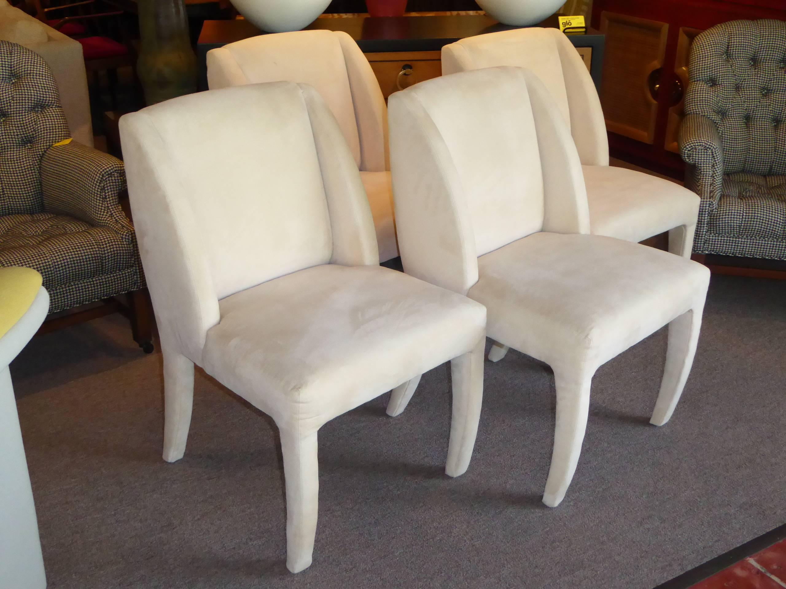 REDUCED FROM $4,850...Set of four 1980s sculptural dining chairs by Directional with original bone ultra suede upholstery. Elegant and plush. Tagged directional custom collection and with directional order tag. Original ultra suede with light wear,