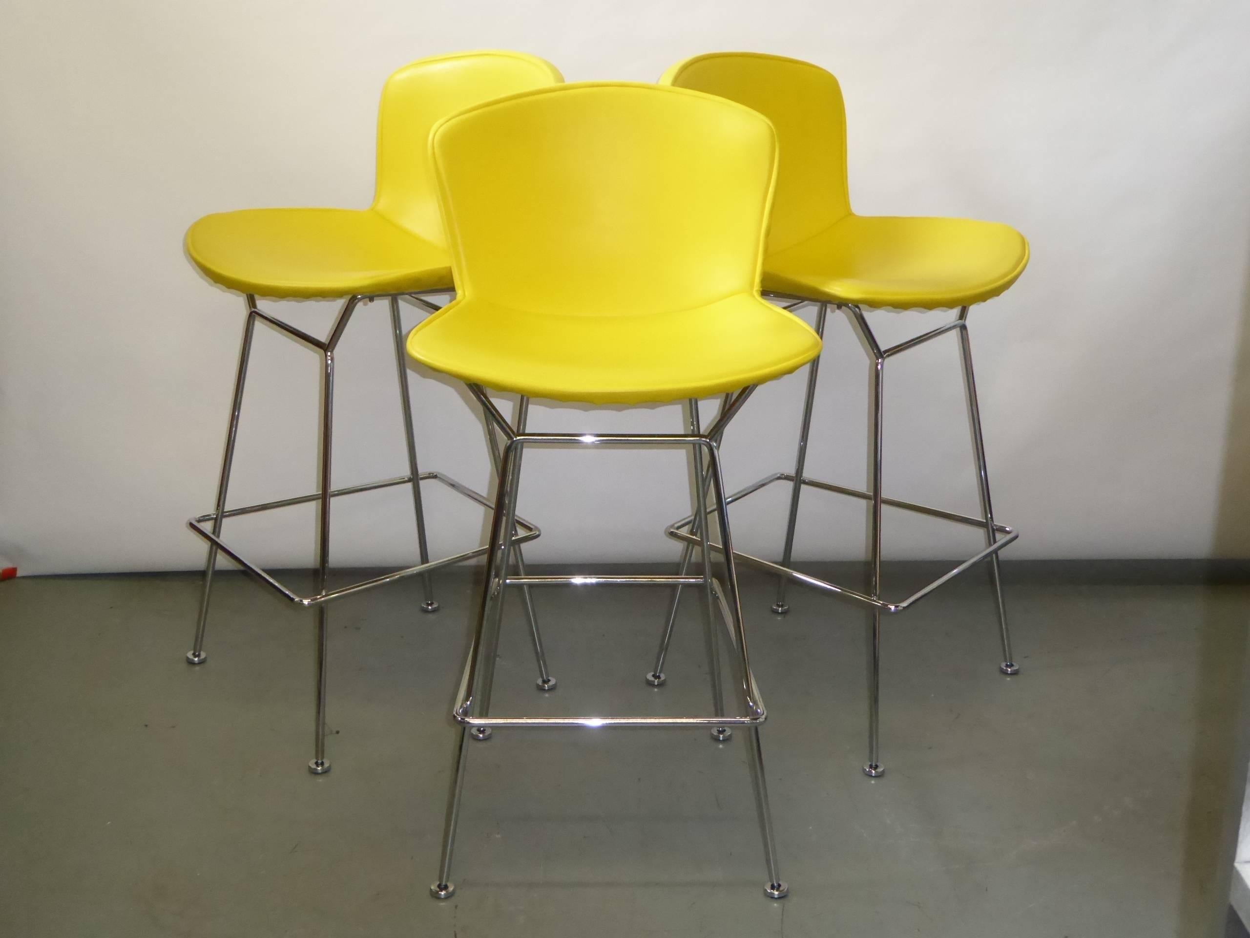 SOLD... Iconic 1952 by Harry Bertoia design for Knoll, three chromed steel bar stools with full leatherette vinyl upholstery in Sunflower yellow.  Full upholstery not available anymore from Knoll.
Seat and base are constructed of welded steel rods