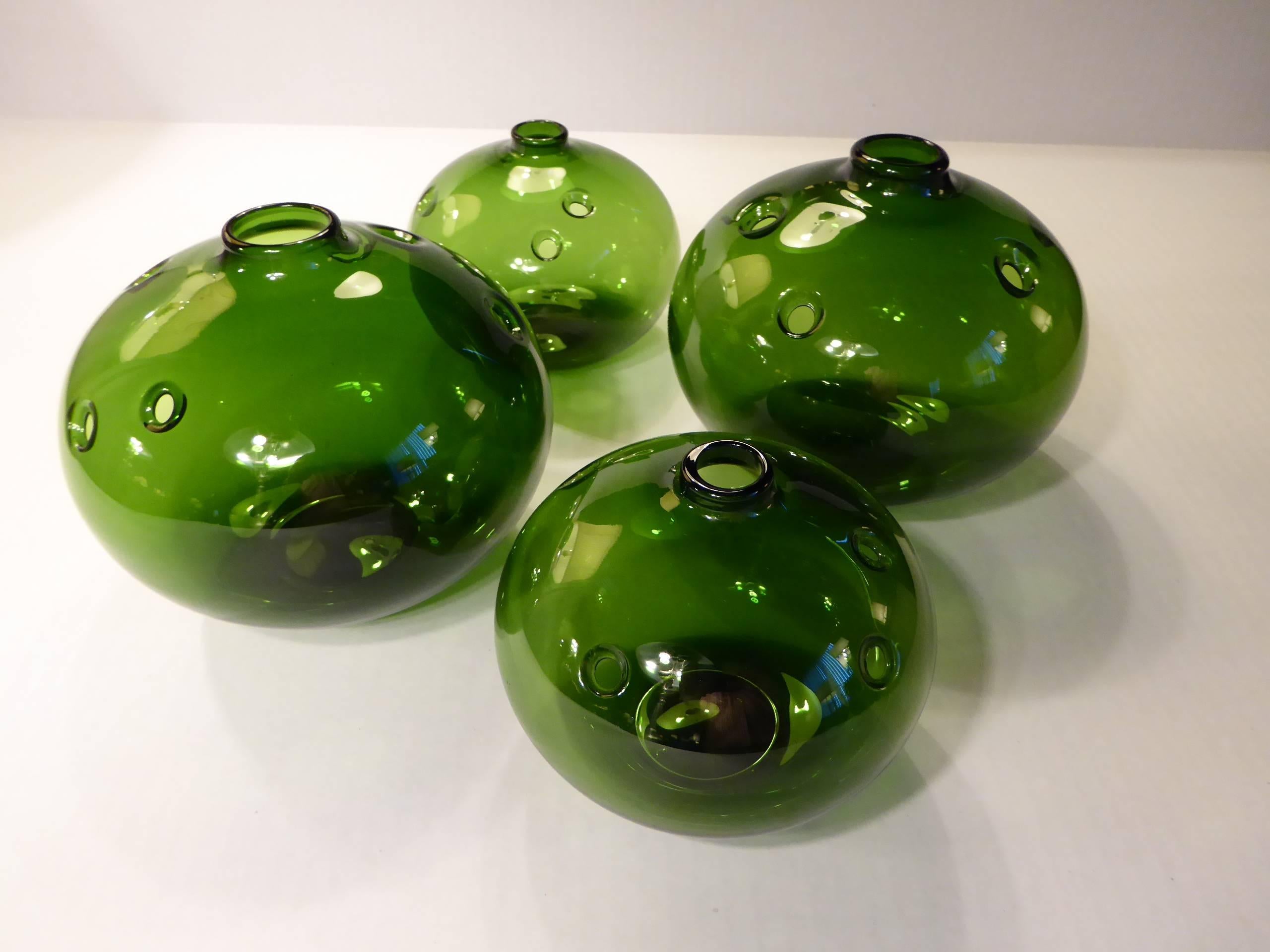 Four hulevaser, from the early 1970s, a design by Michael Bang for Holmegaard, here a grouping of the mouthblown vases that have random holes for flowers. Wonderful grouping for the table center or used separately. All signed MB underneath and in