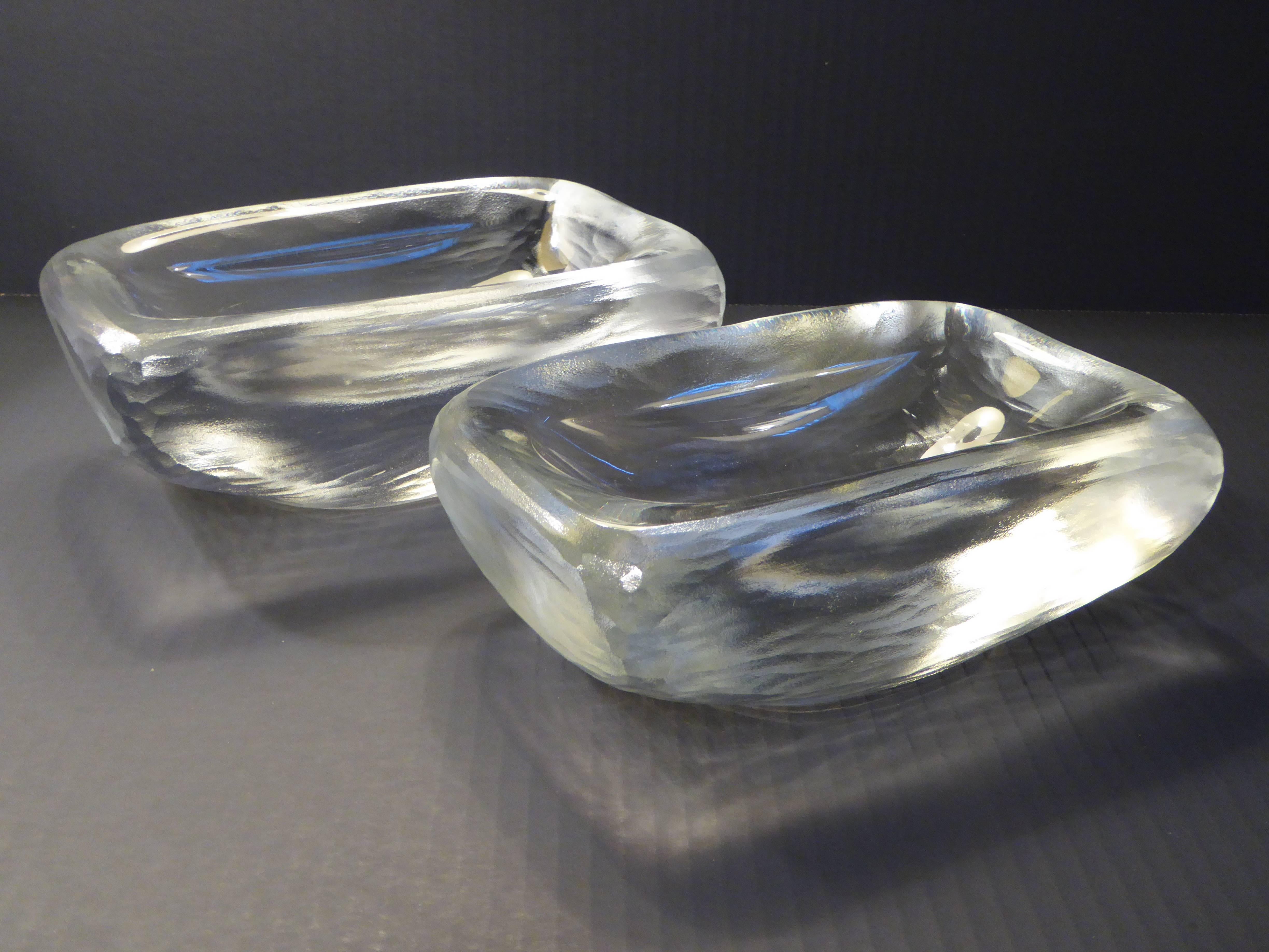 From Orrefors, fat, heavy slabs of poured crystal vessels by noted Swede Vicke Lindstrand using the battuto technique of cutting the glass leaving it with a carved ice appearance. The inner bowl smooth, the outer carved. Very, very heavy and