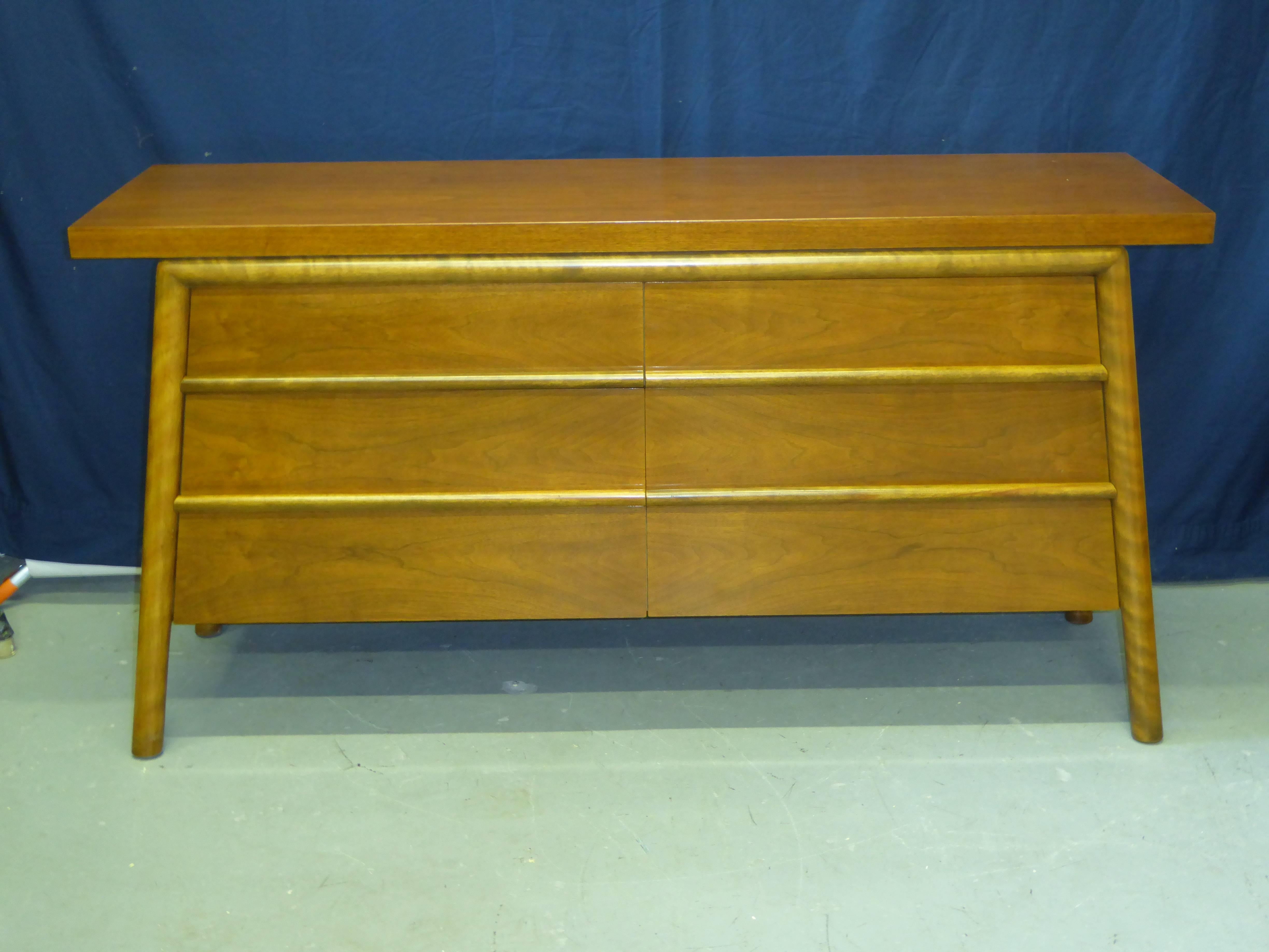 Exquisite bleached walnut credenza by T.H. Robsjohn-Gibbings for Widdicomb dated 1953, featuring six roomy drawers. Unusual A frame shape sides. Excellent original condition with the top repolished. Beautiful walnut figuring. Retains Widdicomb