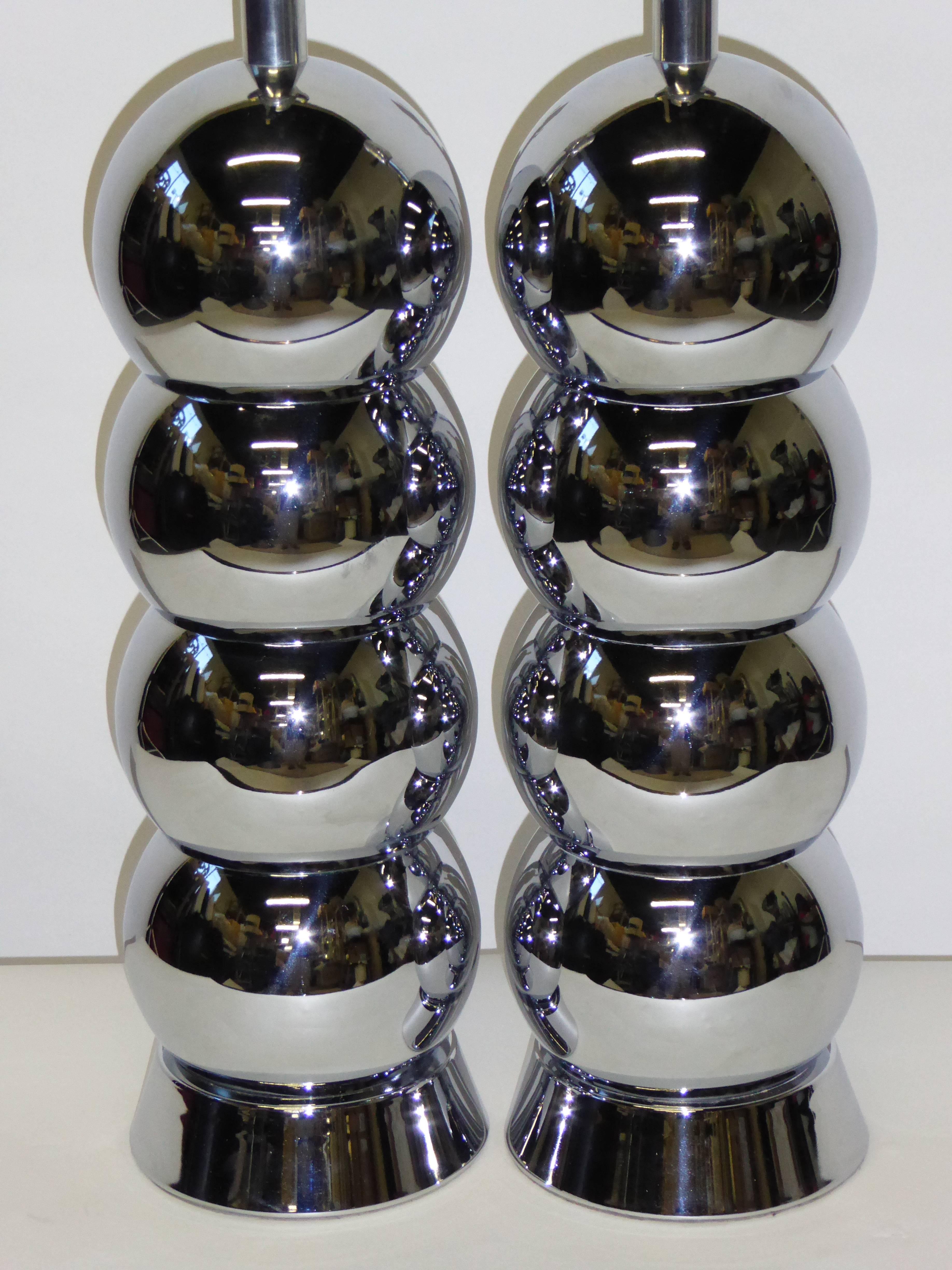 An iconic mid century design by George Kovacs, this pair of stacked chrome ball lamps are architectural and inviting.  In excellent condition with original metallic textural cone shades if desired.  Three level sockets.

Price is for the
