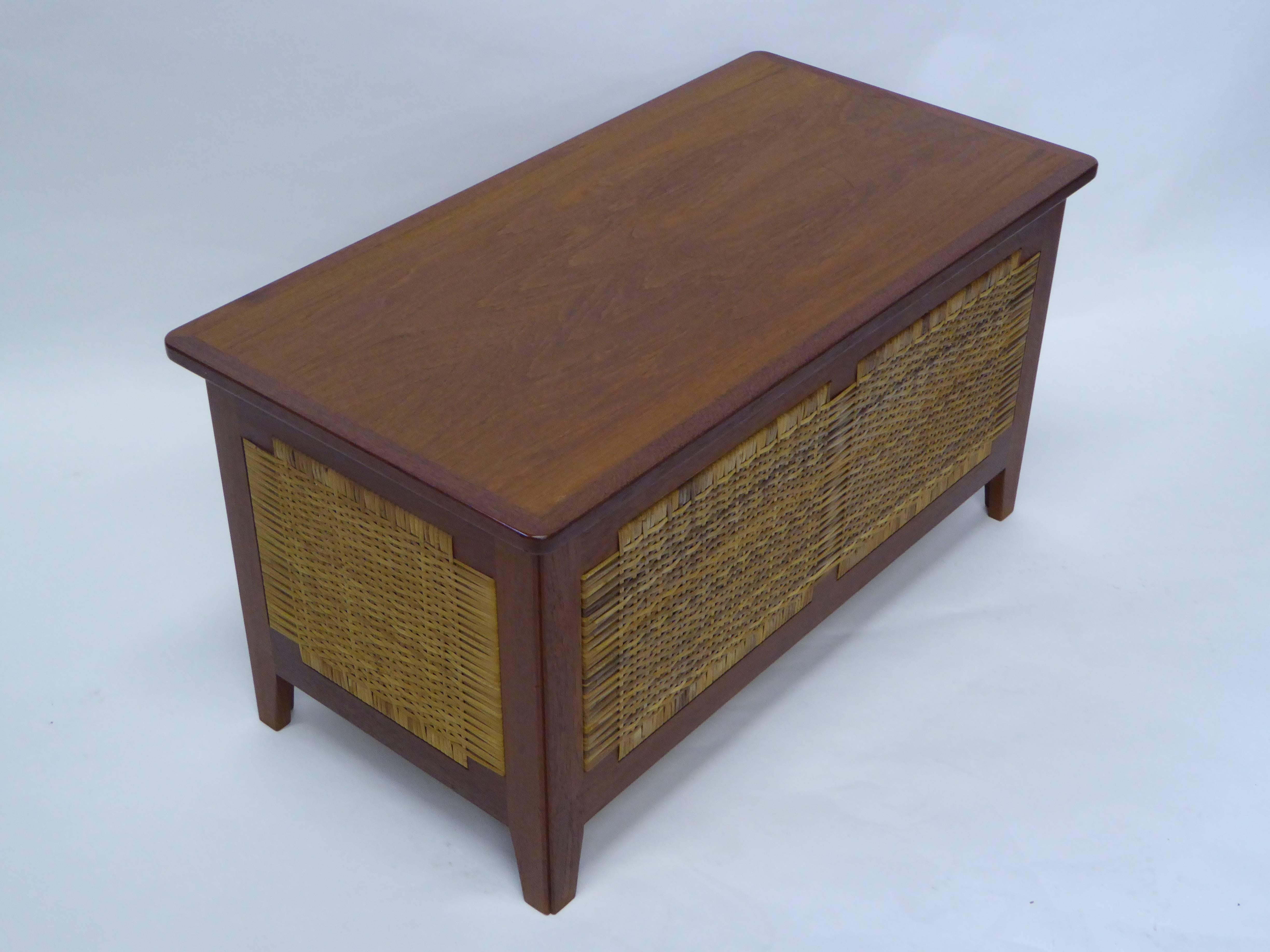 REDUCED FROM $1,850....Beautiful 1960s model PH52 teak chest designed by Kai Winding and produced by Poul Hundevad, Vamdrup, Denmark, featuring a hinged top opening to storage. The sides with caning woven for ventilation. A blanket chest. In