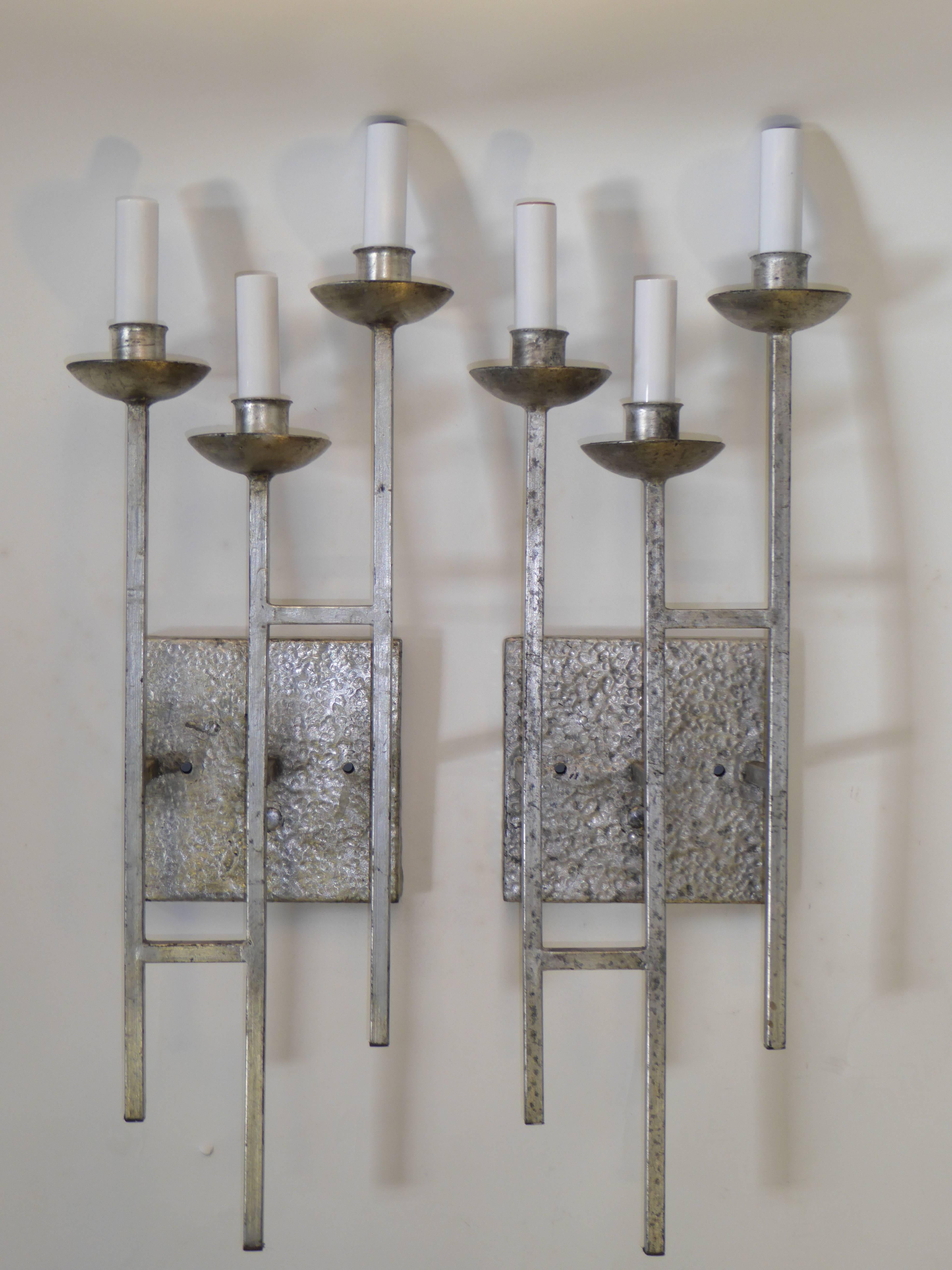 Reduced from $1,200...Beautifully realized early 1960's hammered and silvered metal three candelabra light sconces with a staggered grid rectangular form of square rods and cupped bobeches. Early Brutalist design with Paul Evans inspiration. Height