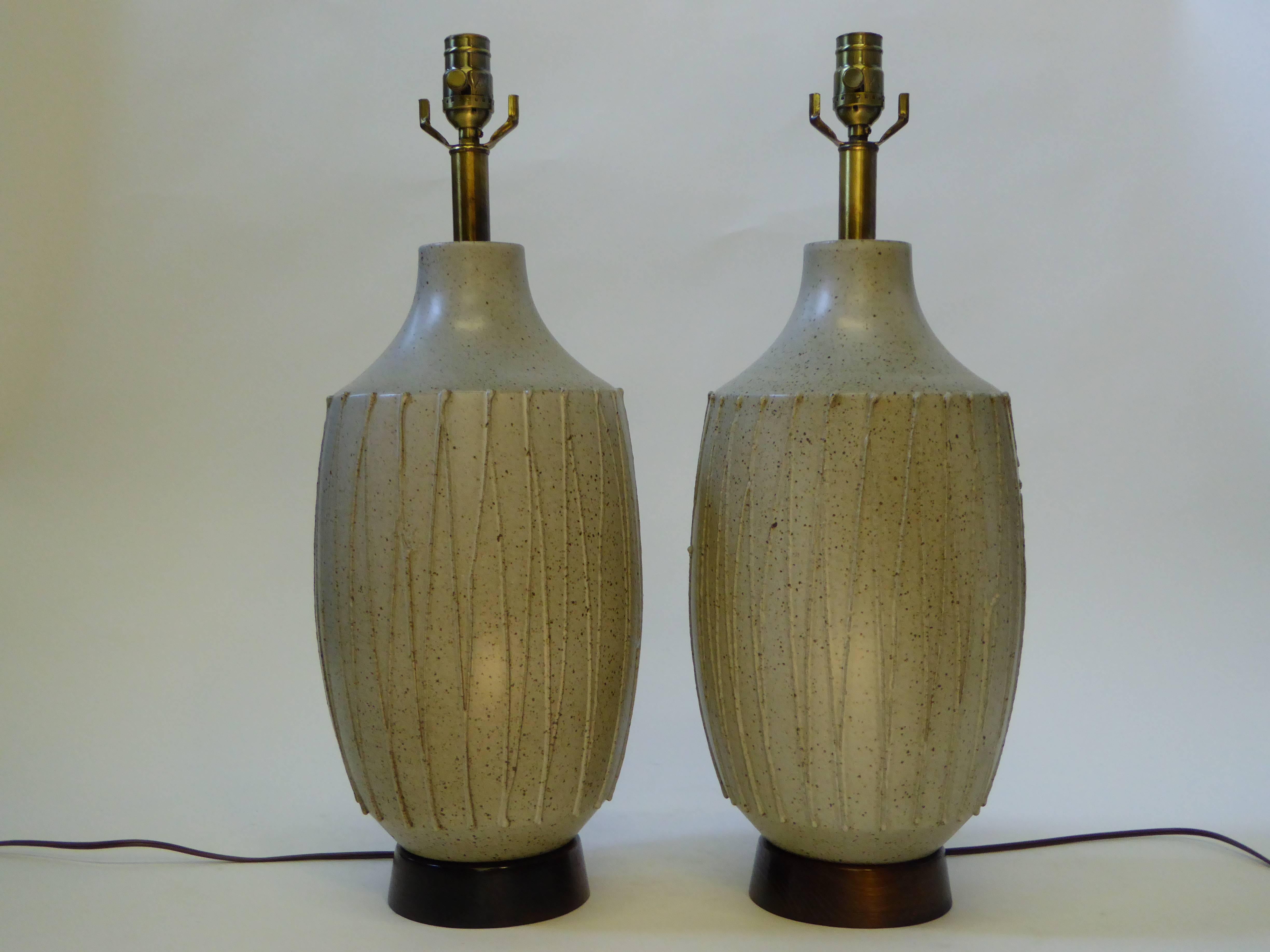 REDUCED FROM $4,850.....Great David Cressey (1916-2013) 1960s pottery table lamps with applied stringing design with speckled brown glaze over pale green grey ground glaze. Large silk with cord shades included if desired. Rewired and with new UL
