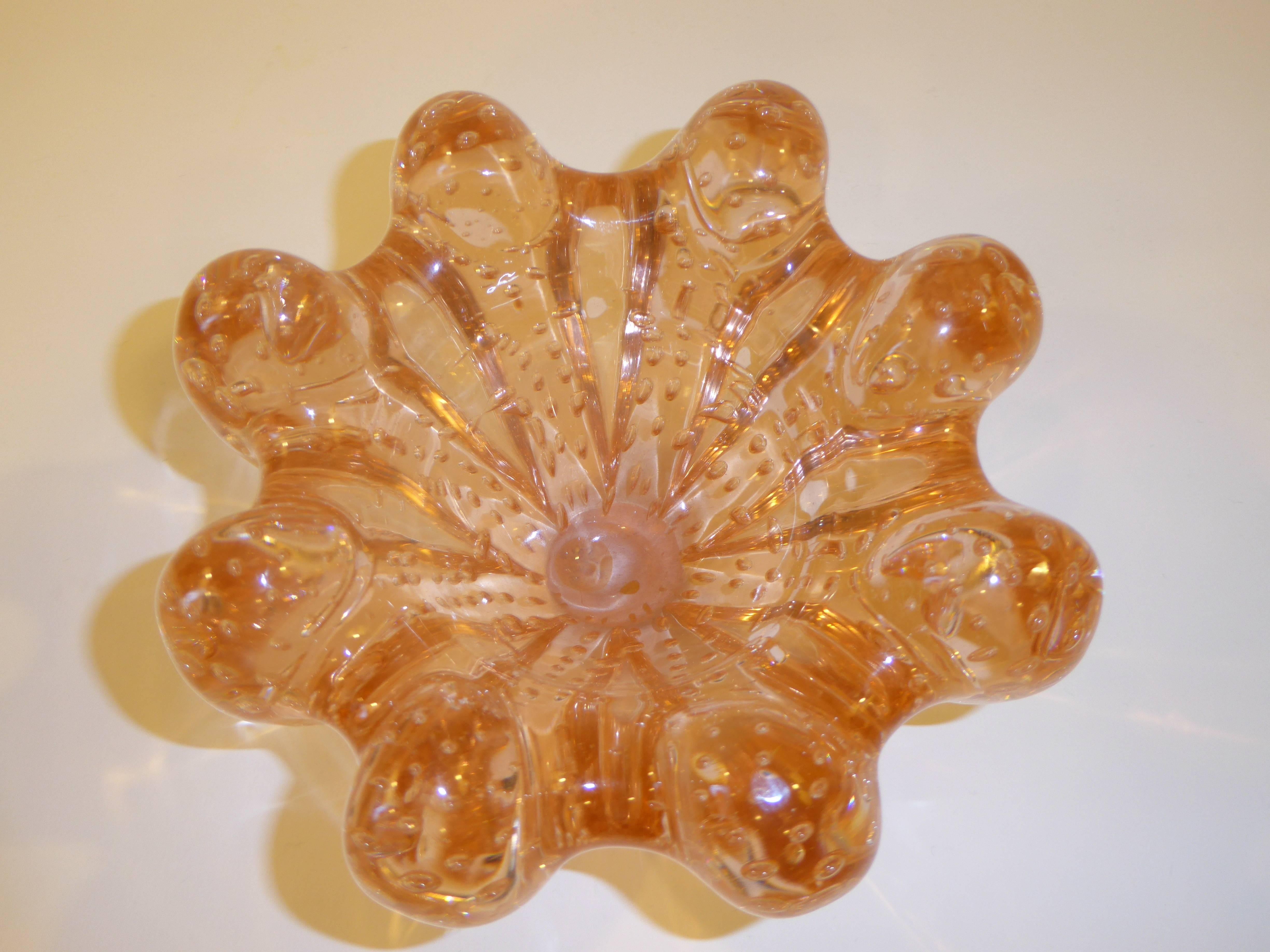 Resembling a sea anemone, this blown glass vessel by Seguso is indeed a delight with its salmon pink color and wealth of interior bubbles. Heavy, thick and wonderfully obese and globular.
Measures 7