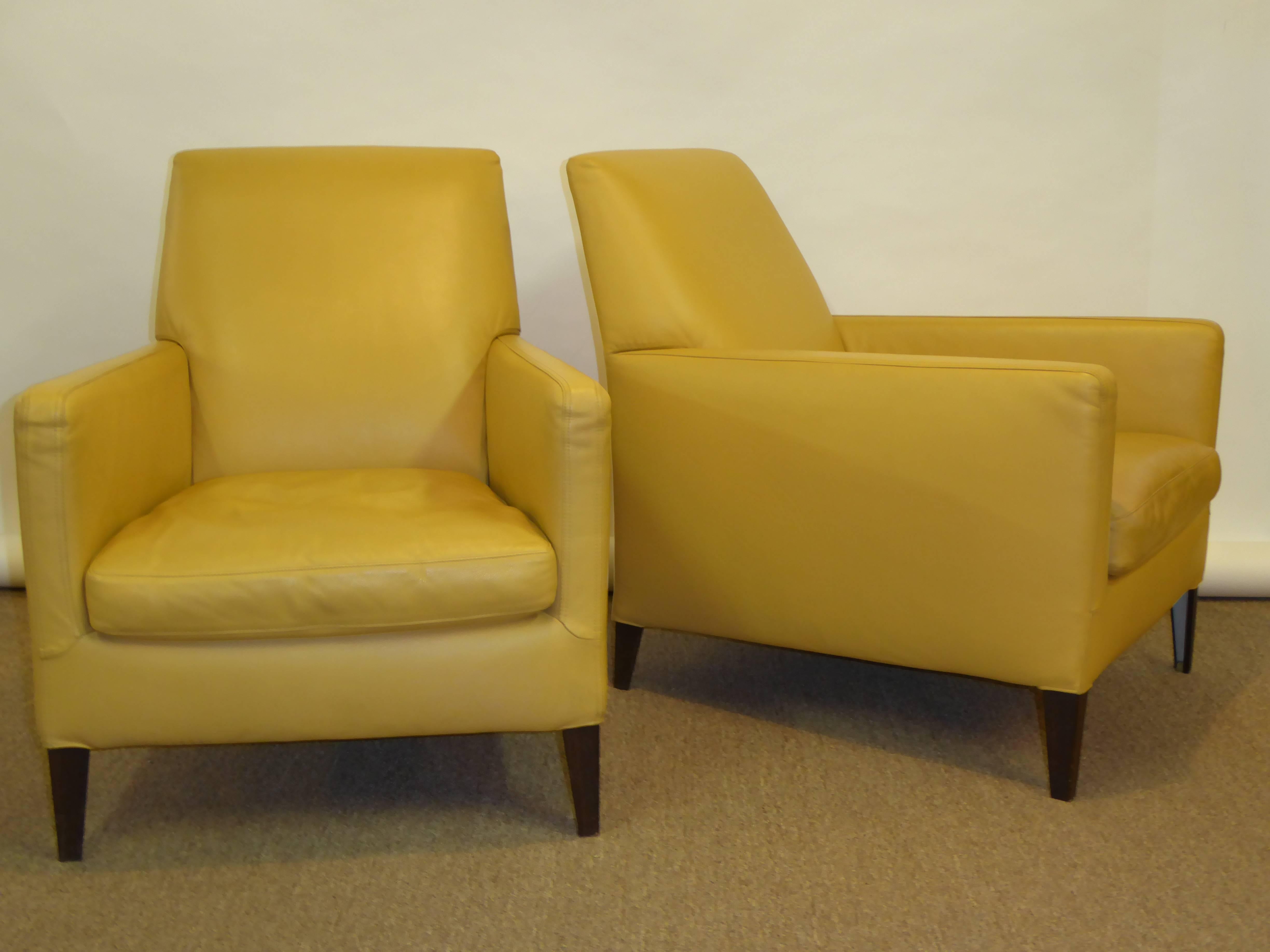 In mustard yellow leather, a pair of Italian lounge chairs designed by Antonio Citterio for Maxalto made by B&B Italia. In sumptuous Italian leather, this pair, named "Dandy", features a tapering shape with the front wider than the