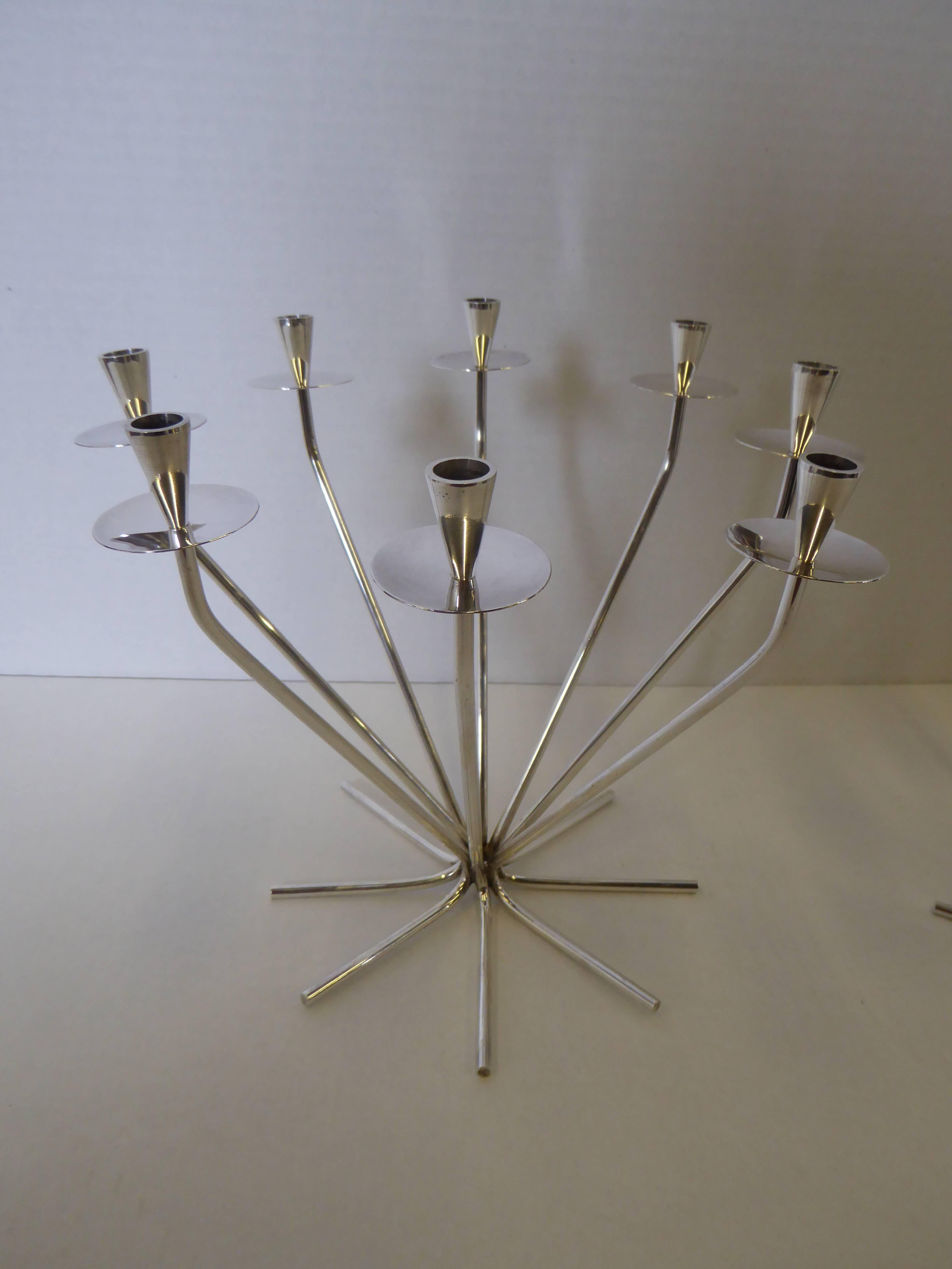 Sculptural pair of modernist candelabra with tubular starburst form rising to bobeches and conical candleholders. Silver plate. Eight candles each candelabra. Each signed in the metal foot E. Dragsted 12 Denmark.
Einar Dragsted (1887-1967) Purveyor