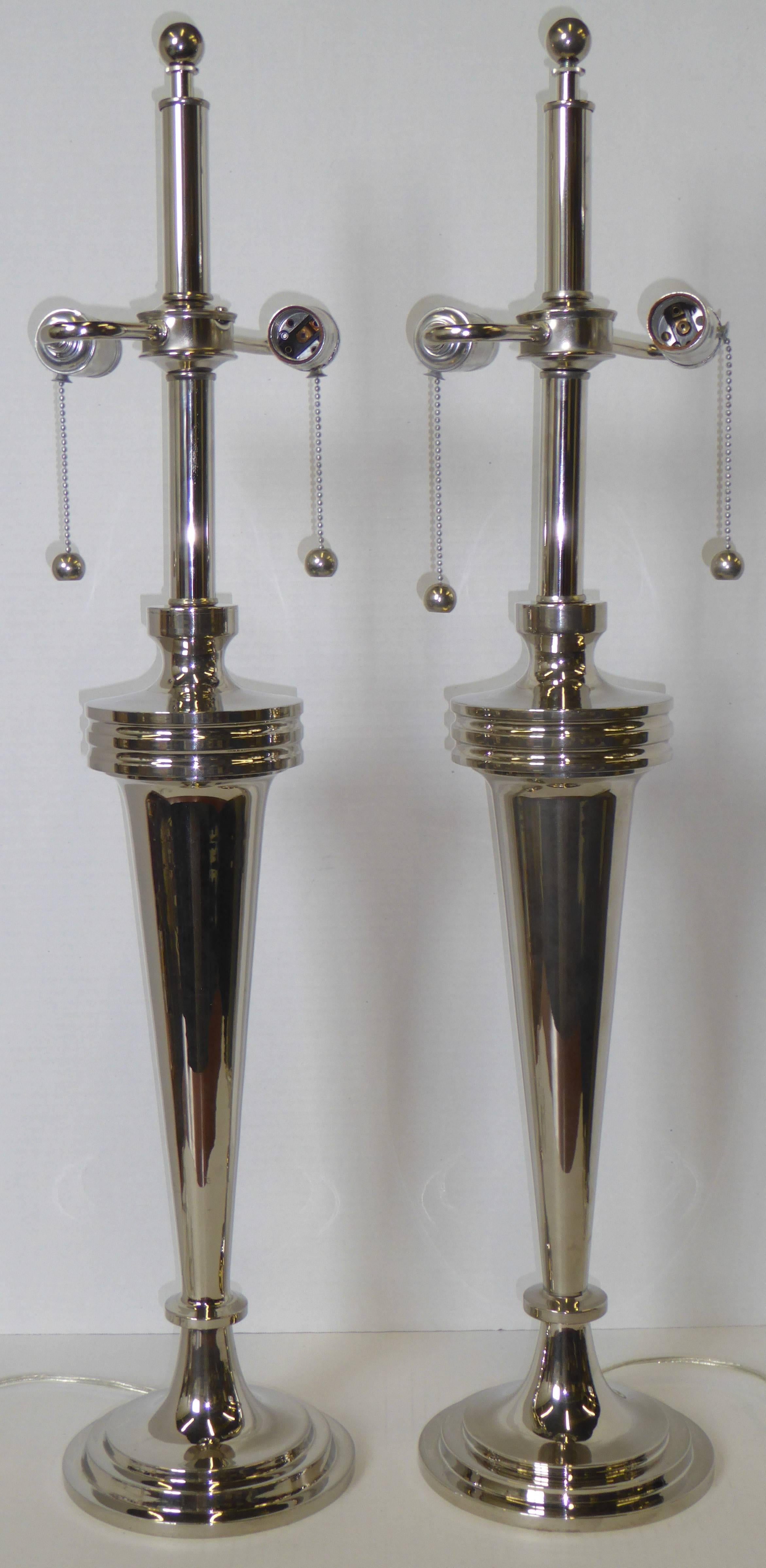 Standing tall and Machine Age elegant, this pair of Art Deco inspired lamps have a urbane and sleek appeal. With double cluster sockets and chain and ball pulls, their form is also Streamline Moderne. Rewired and ready for your shades. Shade shown