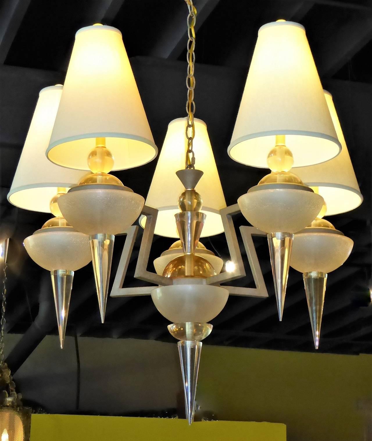 Exquisite 1980s Van Teal creation. A five-light ziggurat motif Chandelier with nude and gold tone Lucite orbs, bowls and spears on a gold tone patinated metal frame. New shades.
Large 36 inches diameter provides impressive presence. Fixture is 36