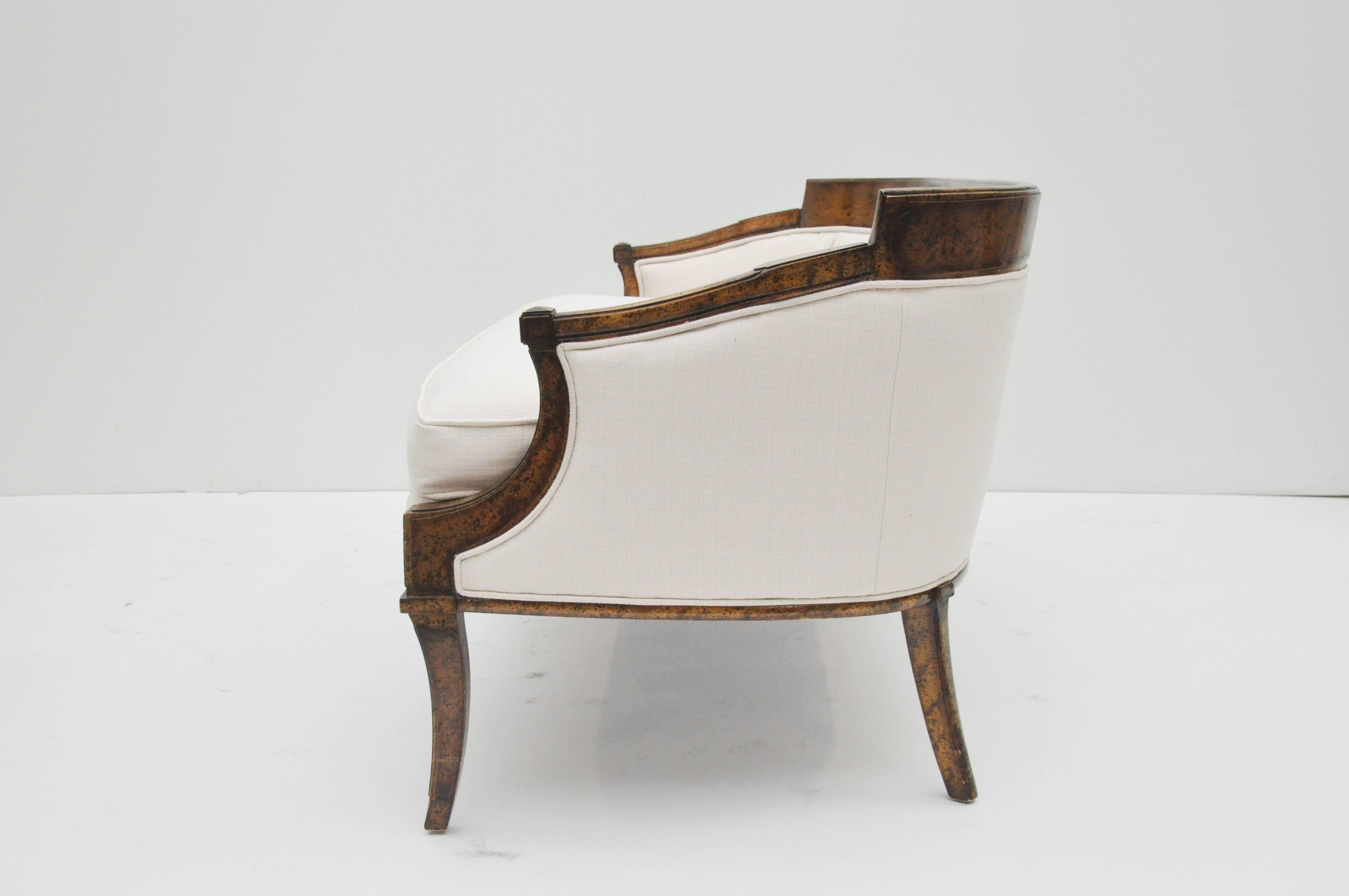 Settee has burled wood detail with off-white new upholstery. Curved lines are elegant. It is a heavy piece. Height of back without cushion on is 26". Piece is beautiful with or without back cushions.