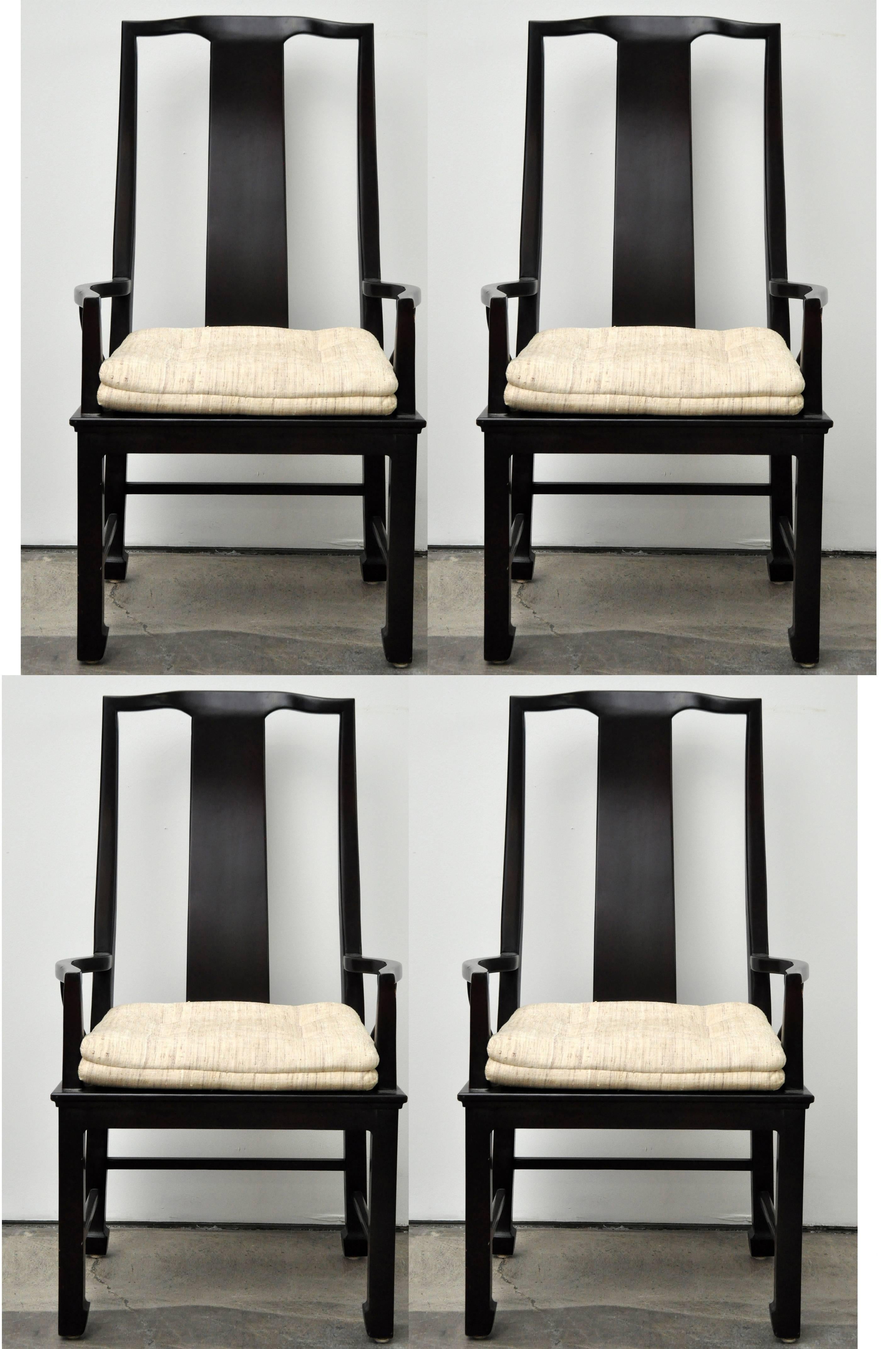 Two pairs of Asian Style armchairs by Chicago based high end furniture company Interior Crafts, Inc. Chairs are beautifully proportioned. Dark black lacquer. With original seat coverings. Seat height listed in dimensions is to the top of cushion.