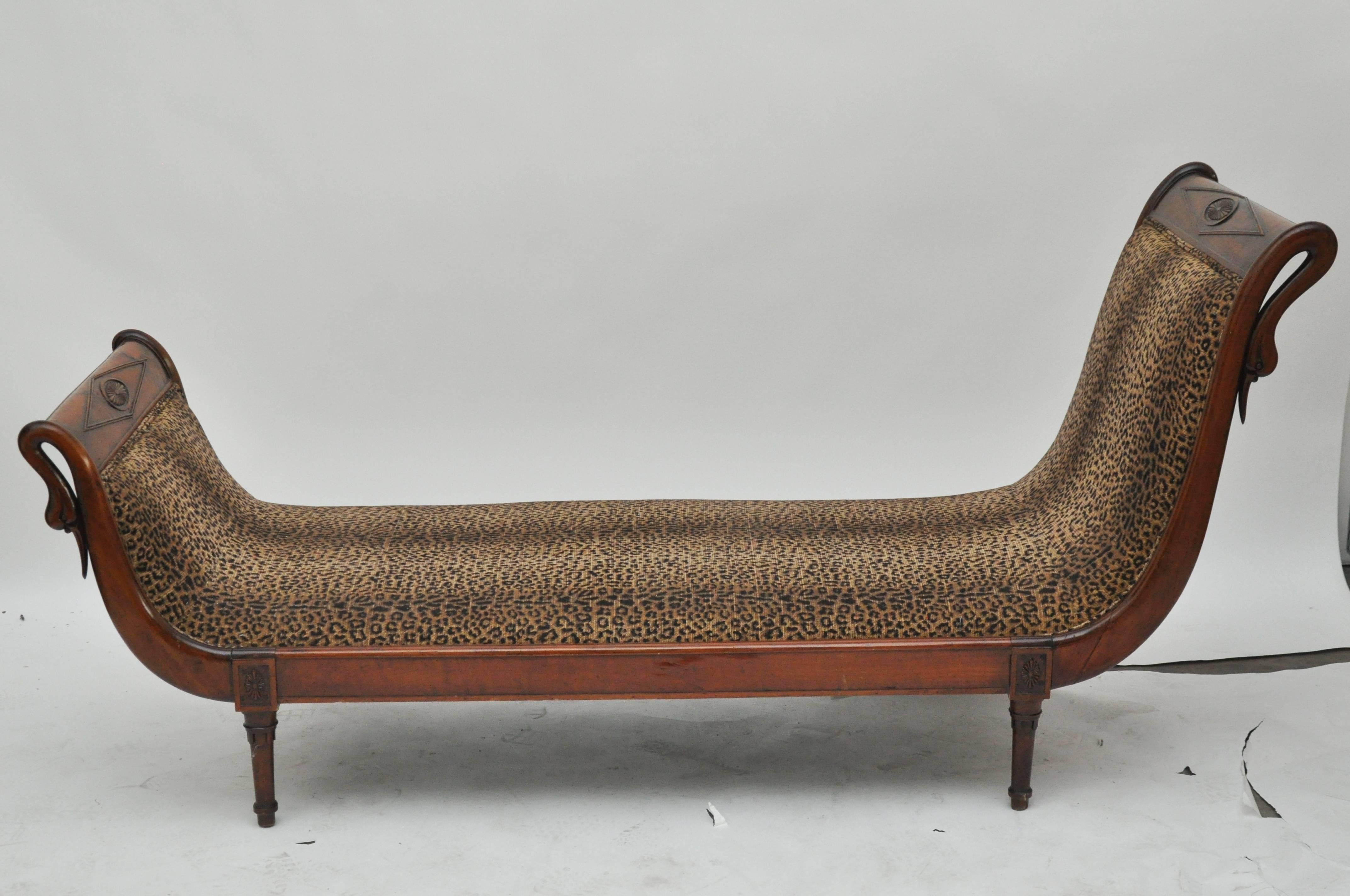 19th century French chaise with carved swans.  Directoire style.  solid mahogany wood.  newly upholstered in leopard print fabric.  the chaise is sturdy and restored.