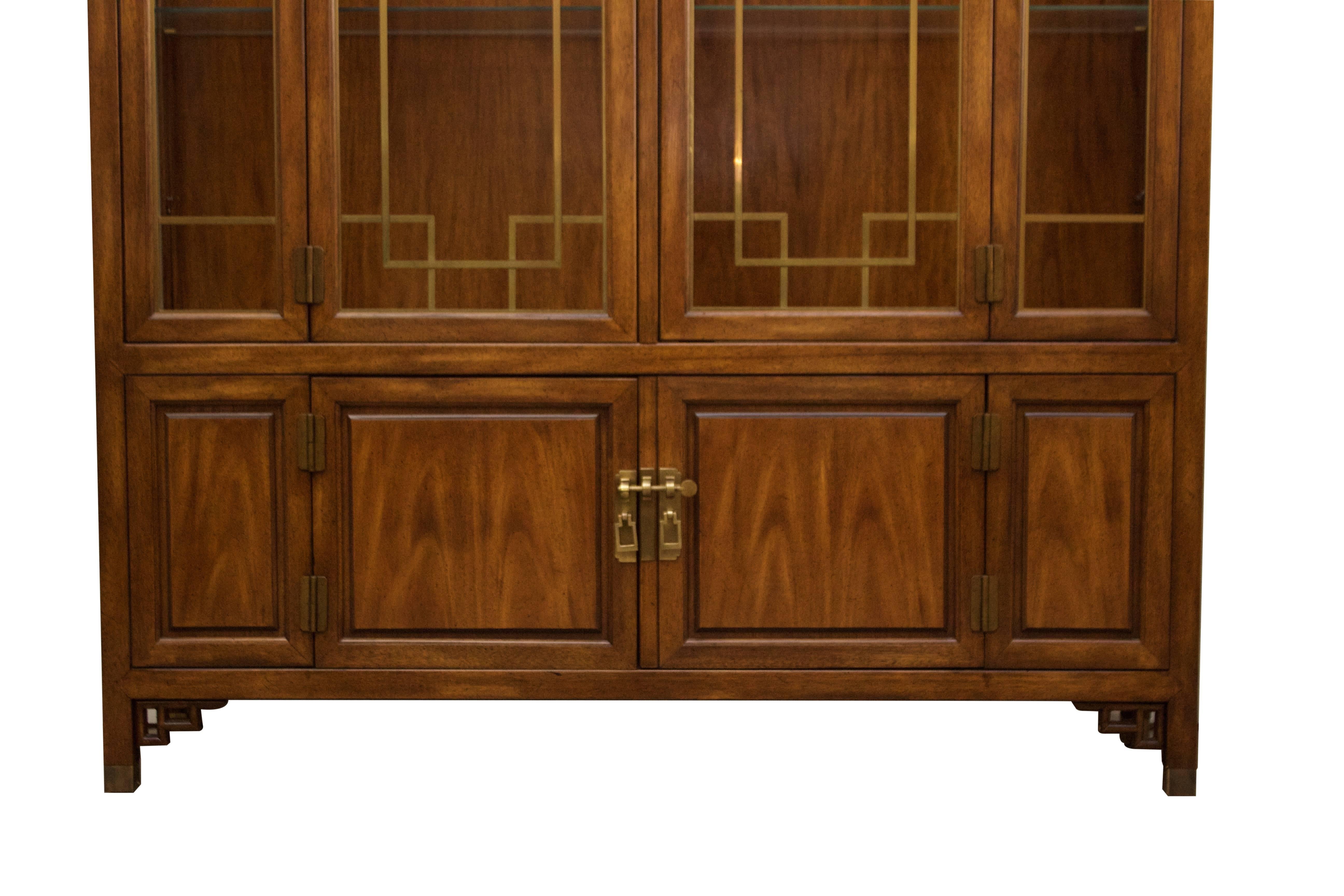 Asian influenced breakfront by Century Furniture. Gorgeous fretwork and brass hardware.